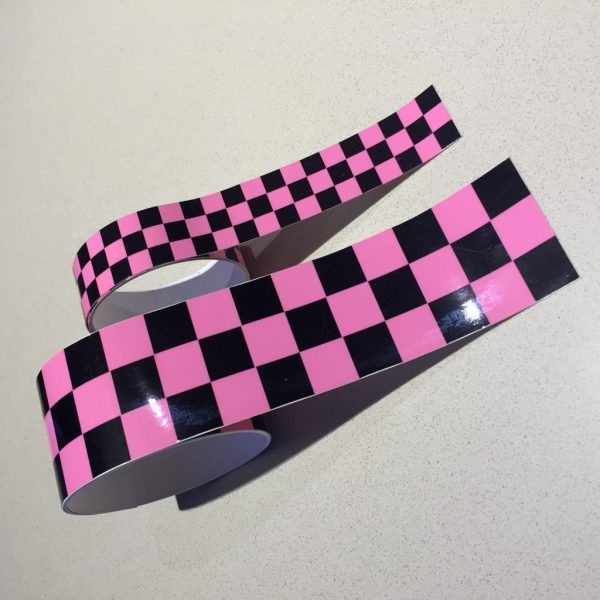 CHEQUERED TAPE PINK. A strip of black and pink chequered tape.