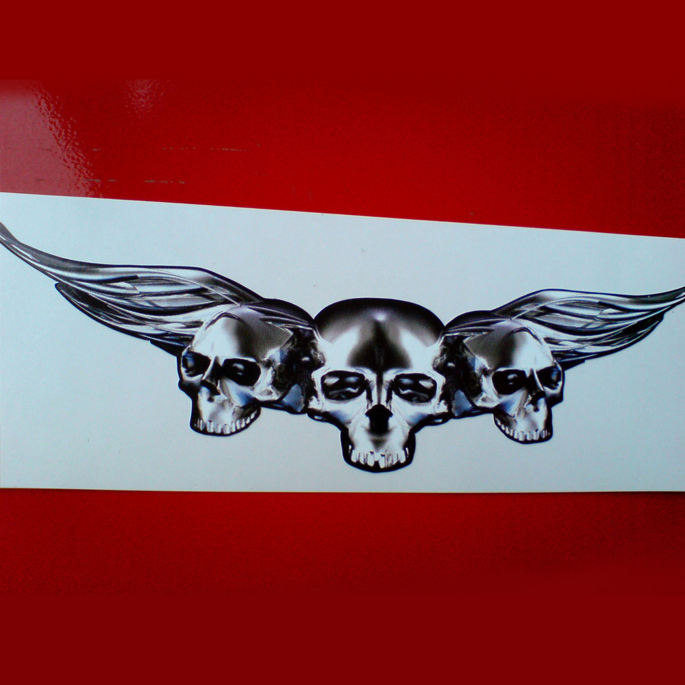 SKULLED WINGS STICKERS. Three skulls in a row covering outstretched wings. The centre skull is larger than the two either side.