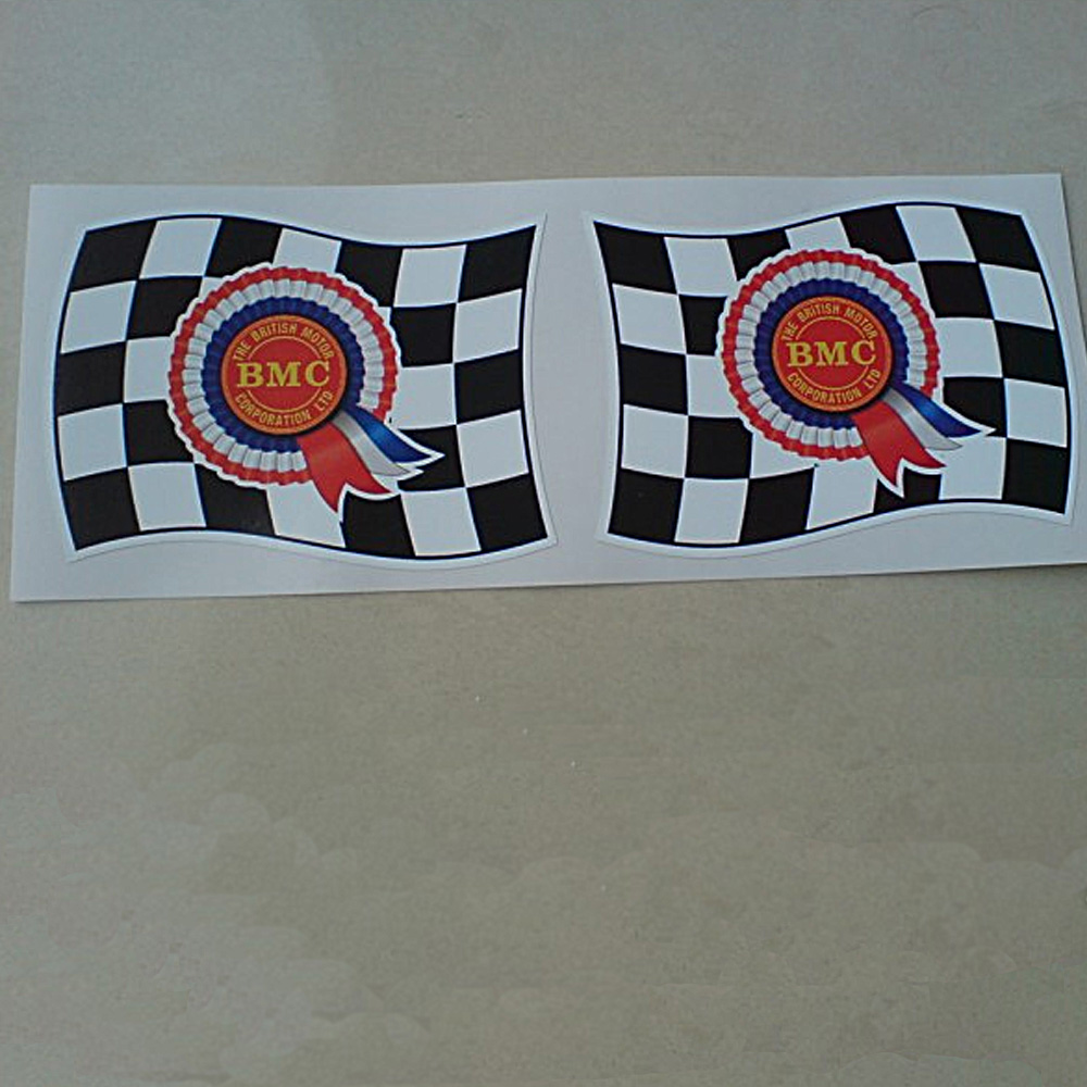 BMC ROSETTE FLAG STICKERS. BMC The British Motor Corporation Ltd in yellow uppercase lettering on a red disc in the centre of a red, white and blue rosette. The rosette is in the centre of a black and white chequered wavy flag.