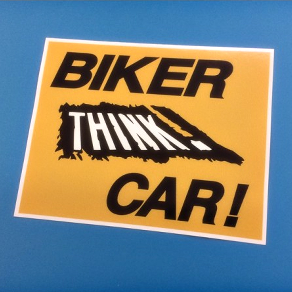 BIKER THINK CAR STICKER. A yellow sticker. Biker in black lettering, Think. in white lettering on black, Car! in black lettering.