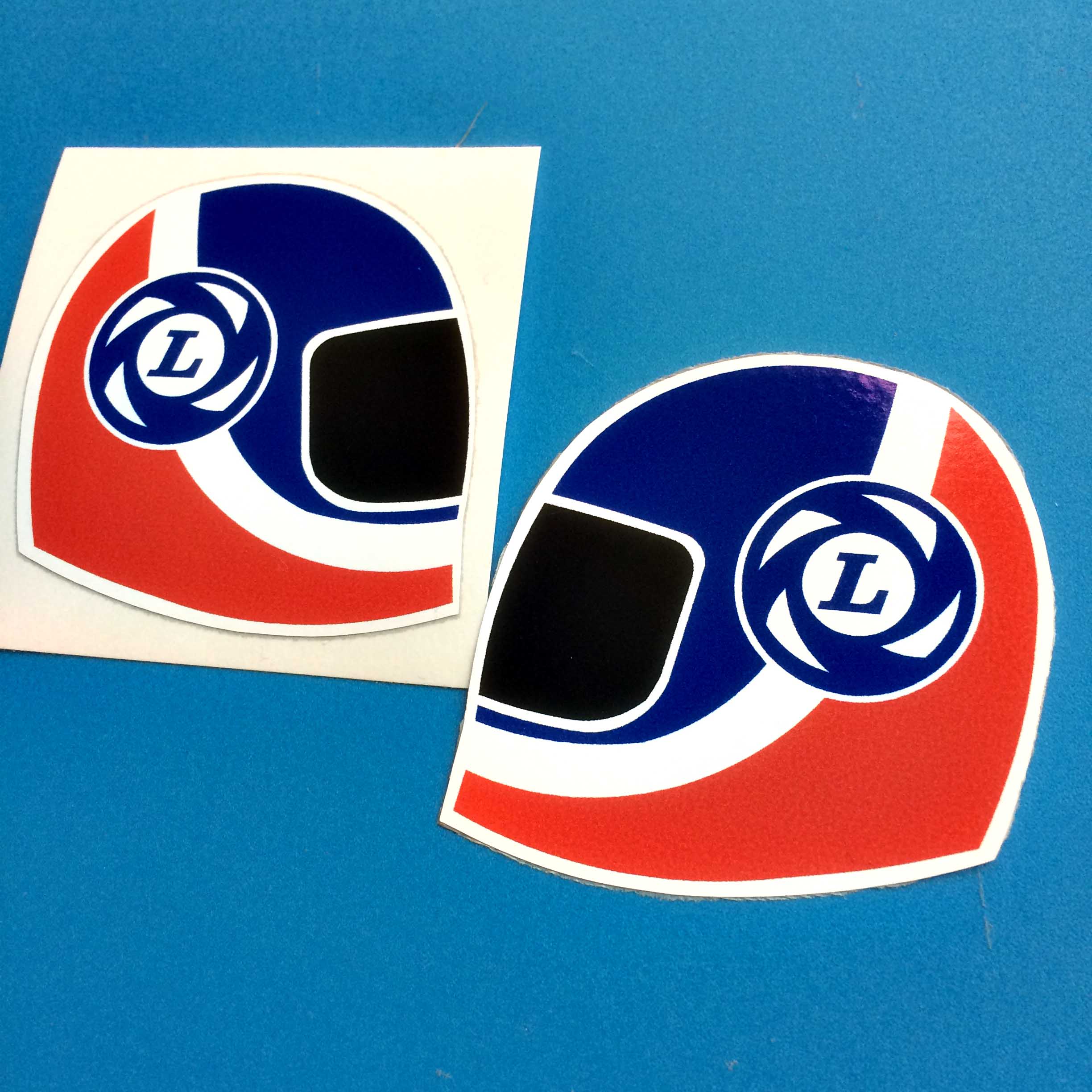 BRITISH LEYLAND HELMET STICKERS. Red, white and blue motorbike helmet. British Leyland blue and white L logo is next to the visor.