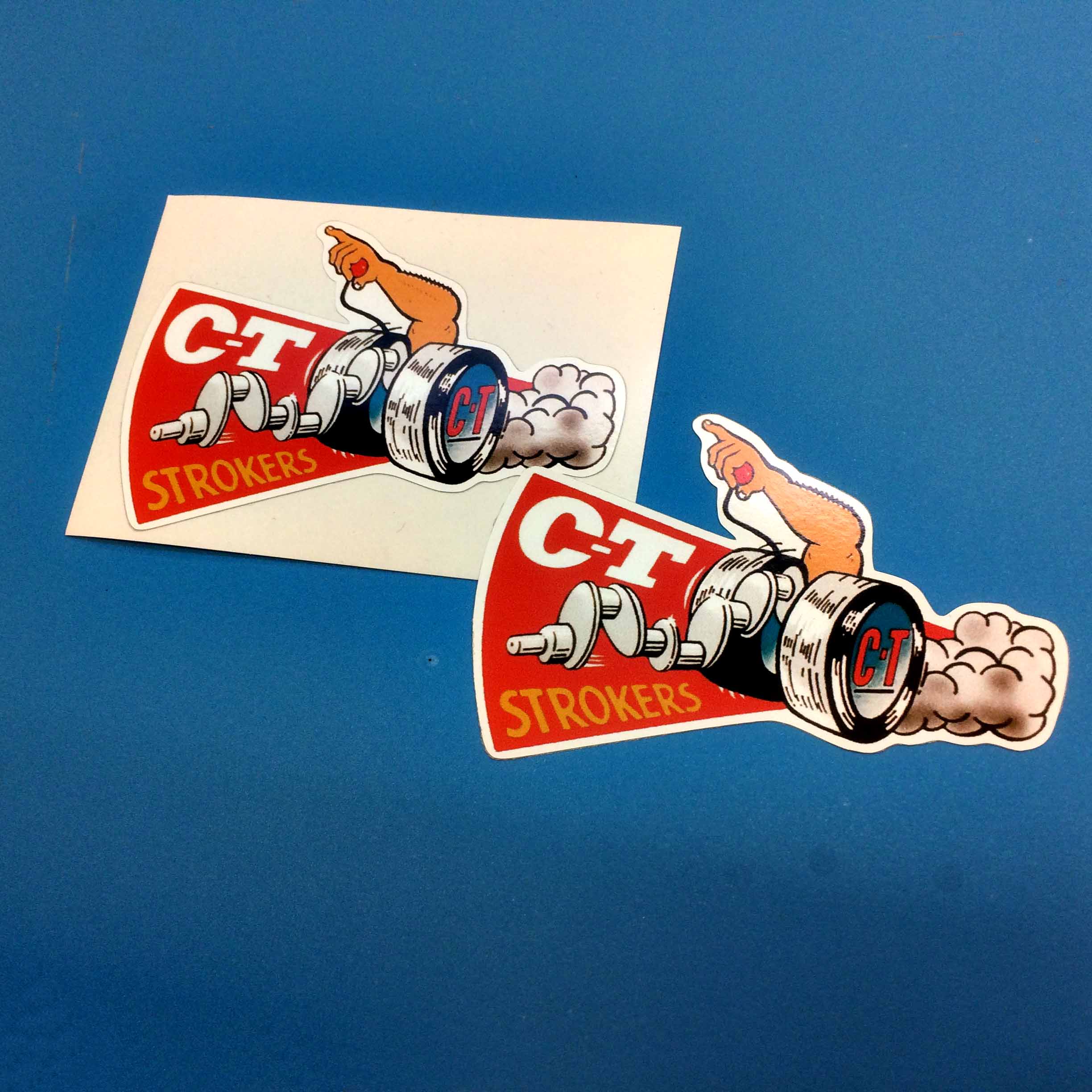 CT STROKERS STICKERS. C-T in white lettering Strokers in yellow lettering on a red background next to a dragster with smoke coming from the back and a man's arm rising up between the wheels.