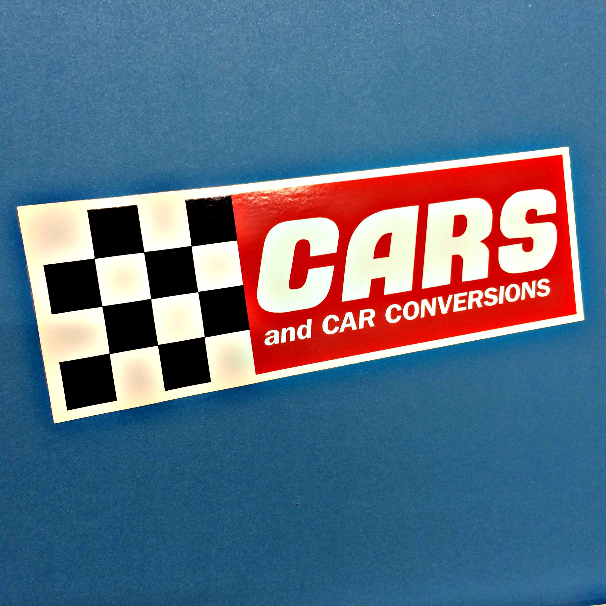 Cars and Car Conversions in white uppercase lettering on a red rectangular background next to a black and white chequer square.