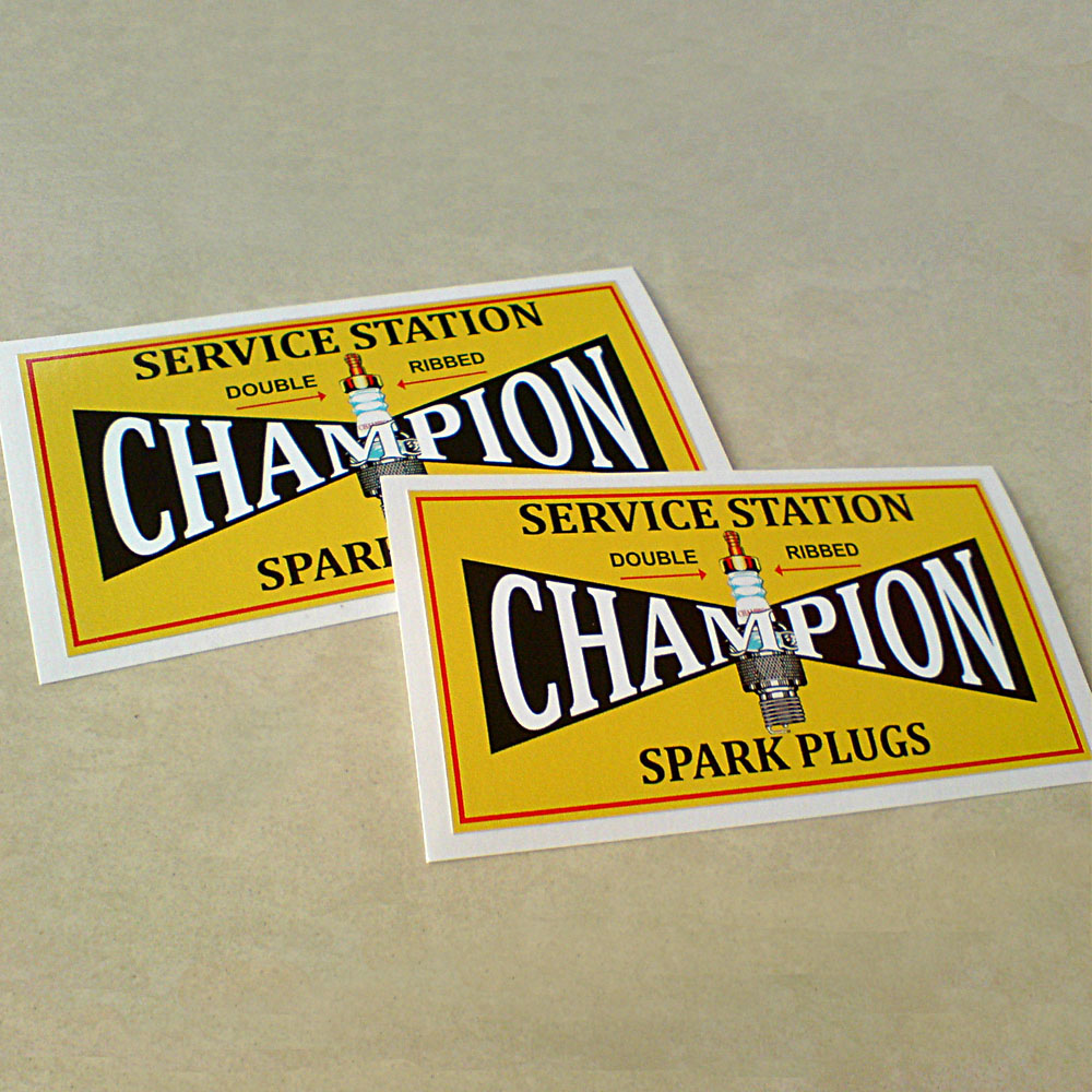 CHAMPION SPARK PLUG STICKERS. A yellow sticker with a red border. Champion in uppercase white lettering on a black background with a spark plug in the centre. Additional text in black lettering; Service Station Double Ribbed (underlined in red) Spark Plugs.