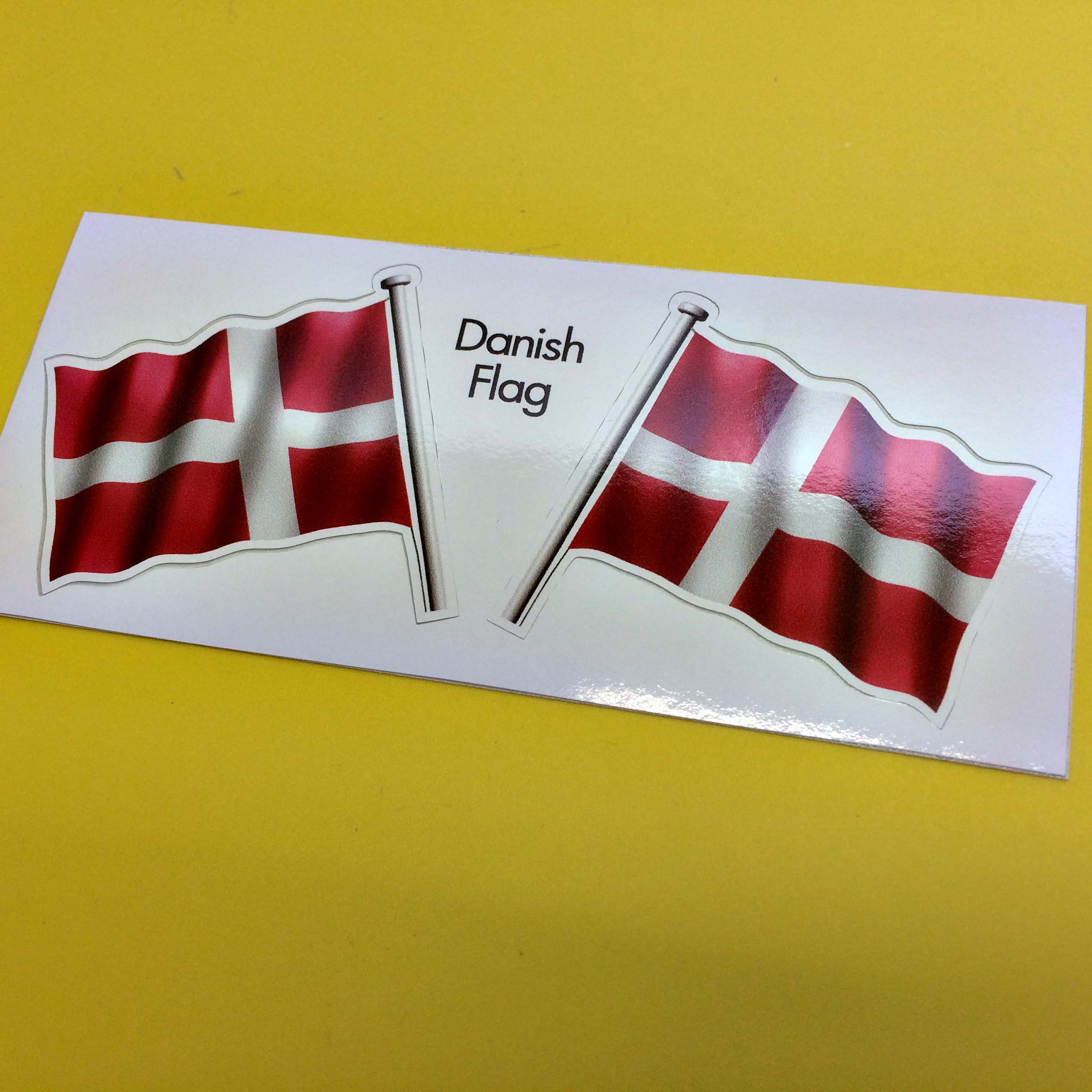 DENMARK FLAG AND POLE STICKERS. A wavy flag of Denmark on a pole. A white cross on a red background.