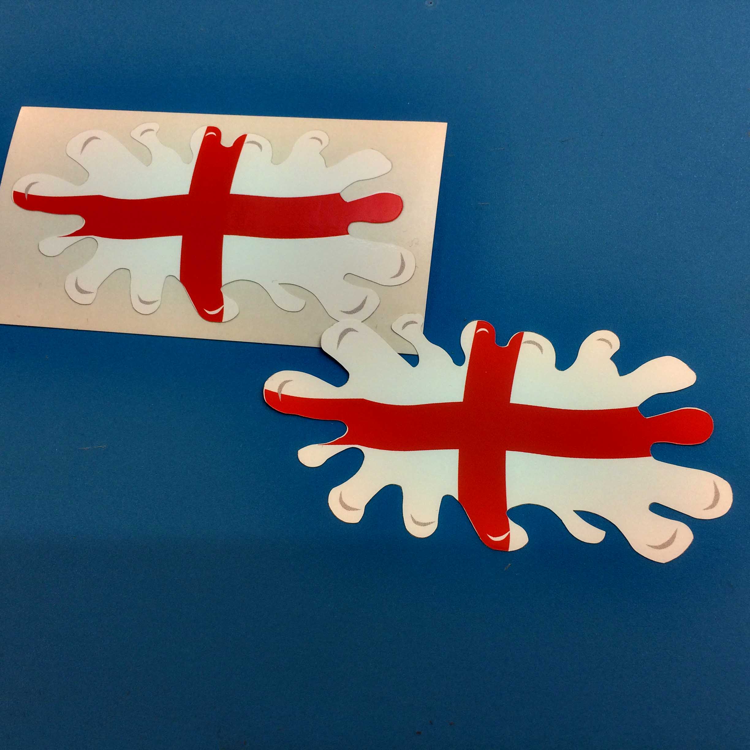 ENGLAND FLAG SPLAT ST. GEORGE STICKERS. A red cross on a white field. The England flag in the shape of a splat of paint.