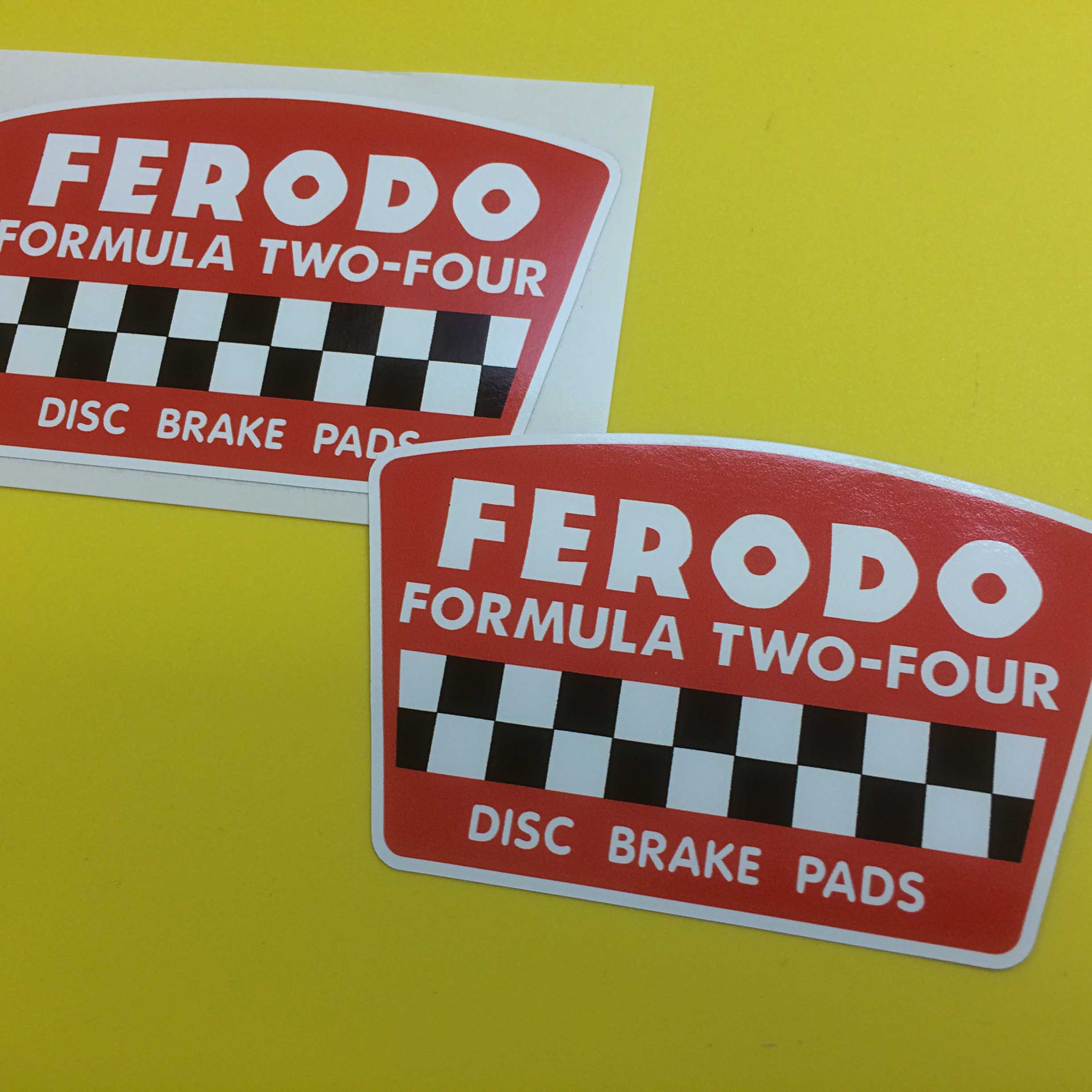 FERODO FORMULA TWO FOUR STICKERS. Ferodo Formula Two-Four Disc Brake Pads in white lettering and a strip of black and white chequer on a red sticker.