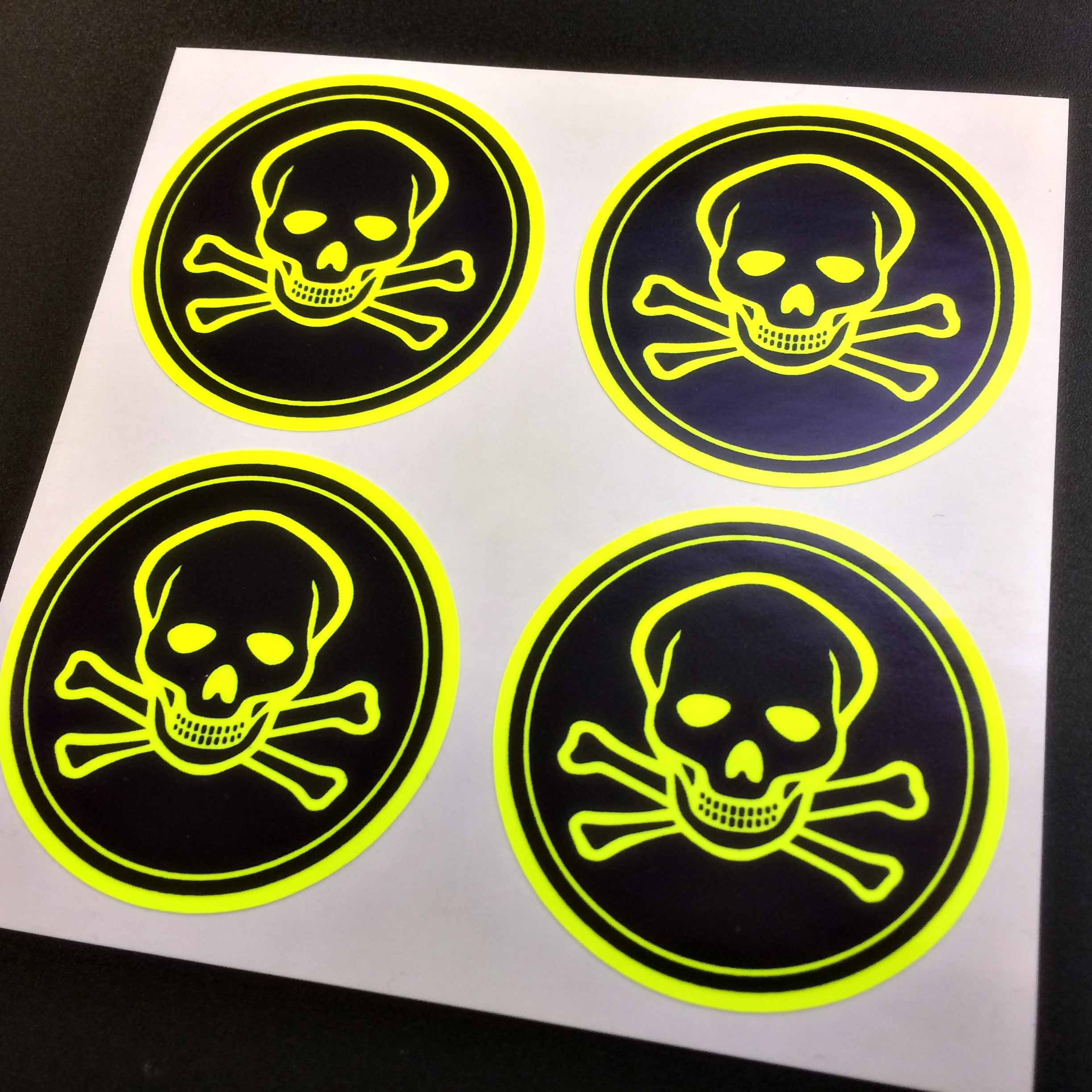 A fluorescent yellow skull and crossbones on a black sticker bordered in fluorescent yellow.