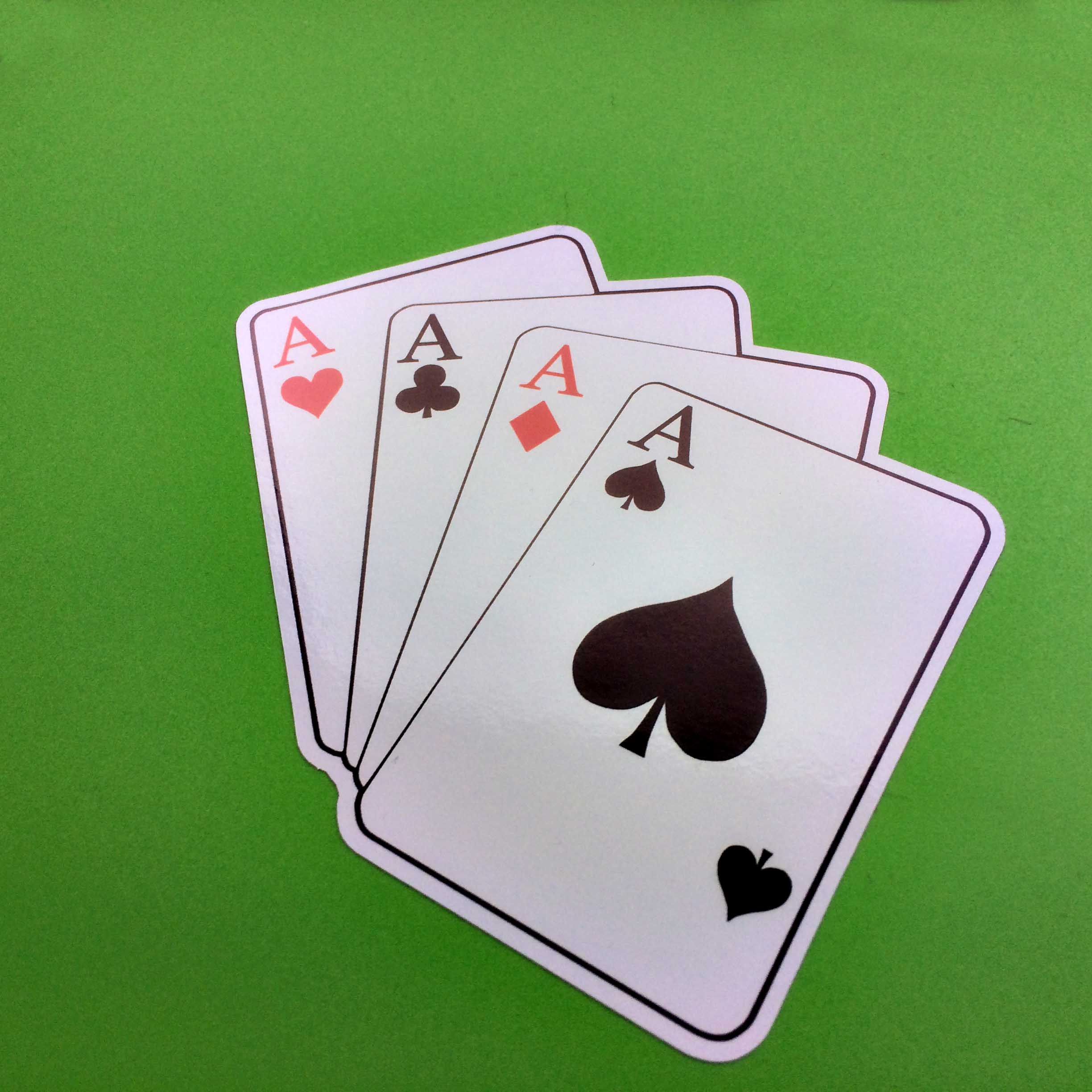 A fan of four aces playing cards. The black ace of spades and clubs; the red ace of hearts and diamonds.