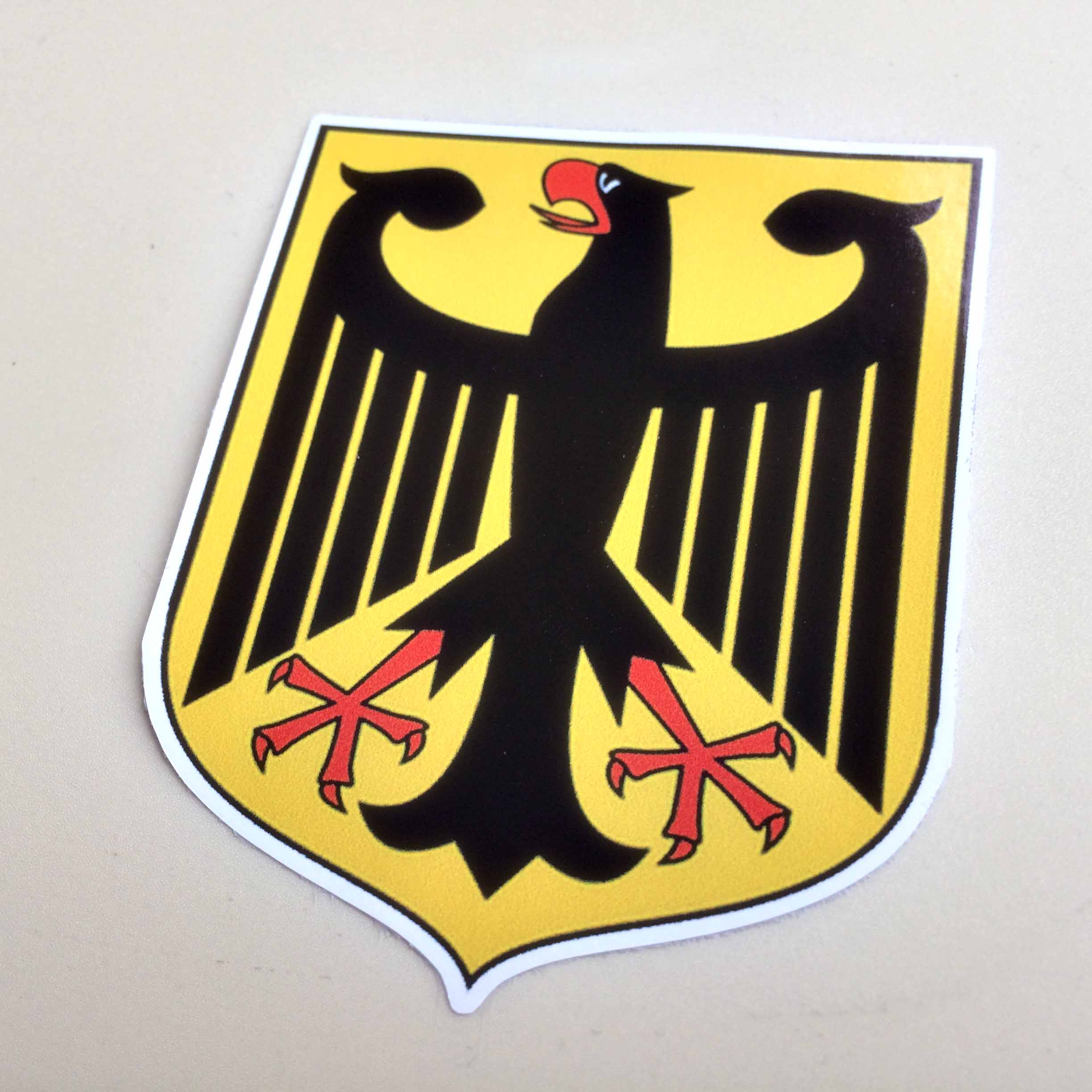 GERMAN COAT OF ARMS GERMANY EAGLE STICKER. A black eagle with a red beak, a red tongue and red talons on a golden field.