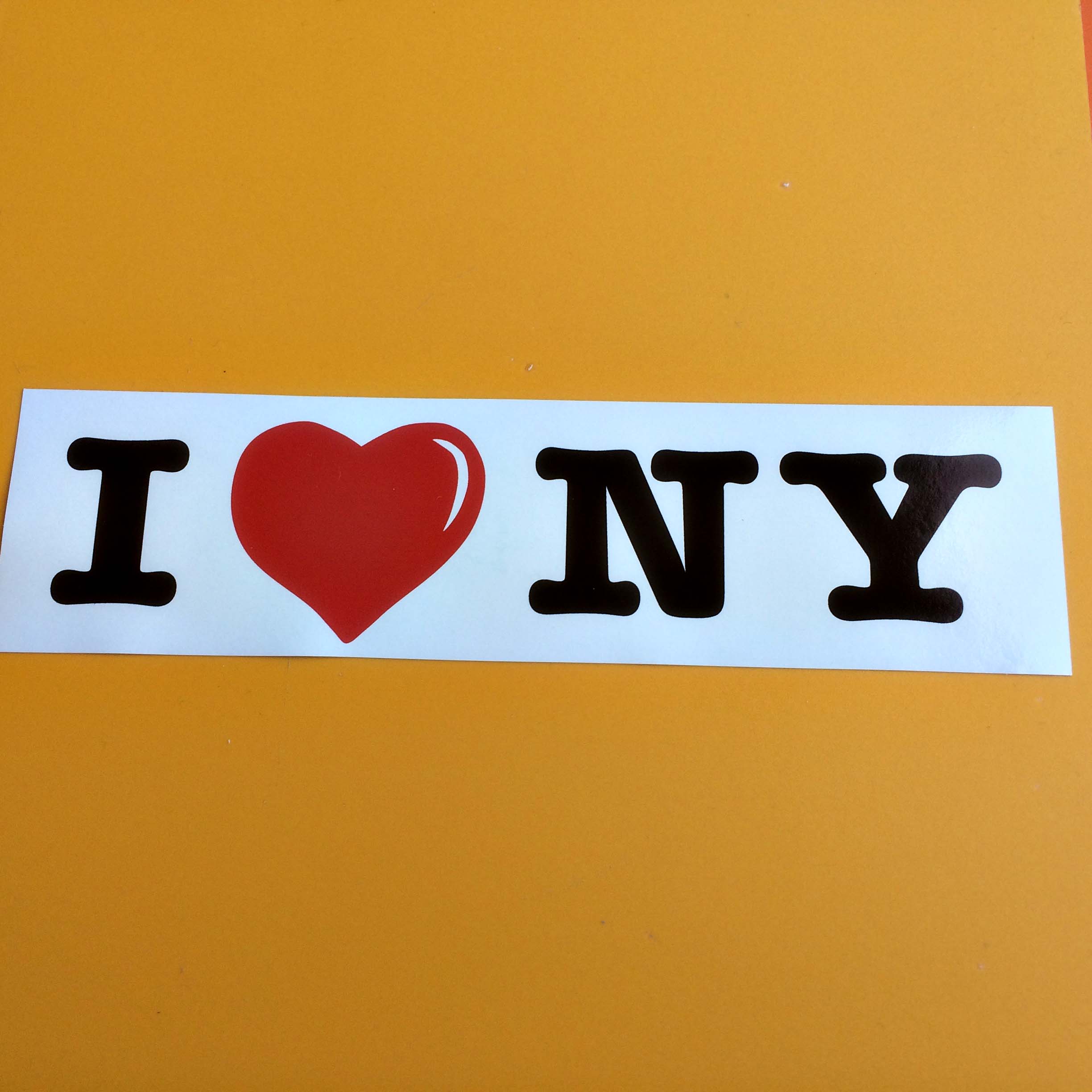 I LOVE NEW YORK STICKER. The letters I and NY in bold black lettering either side of a red love heart on a white background.