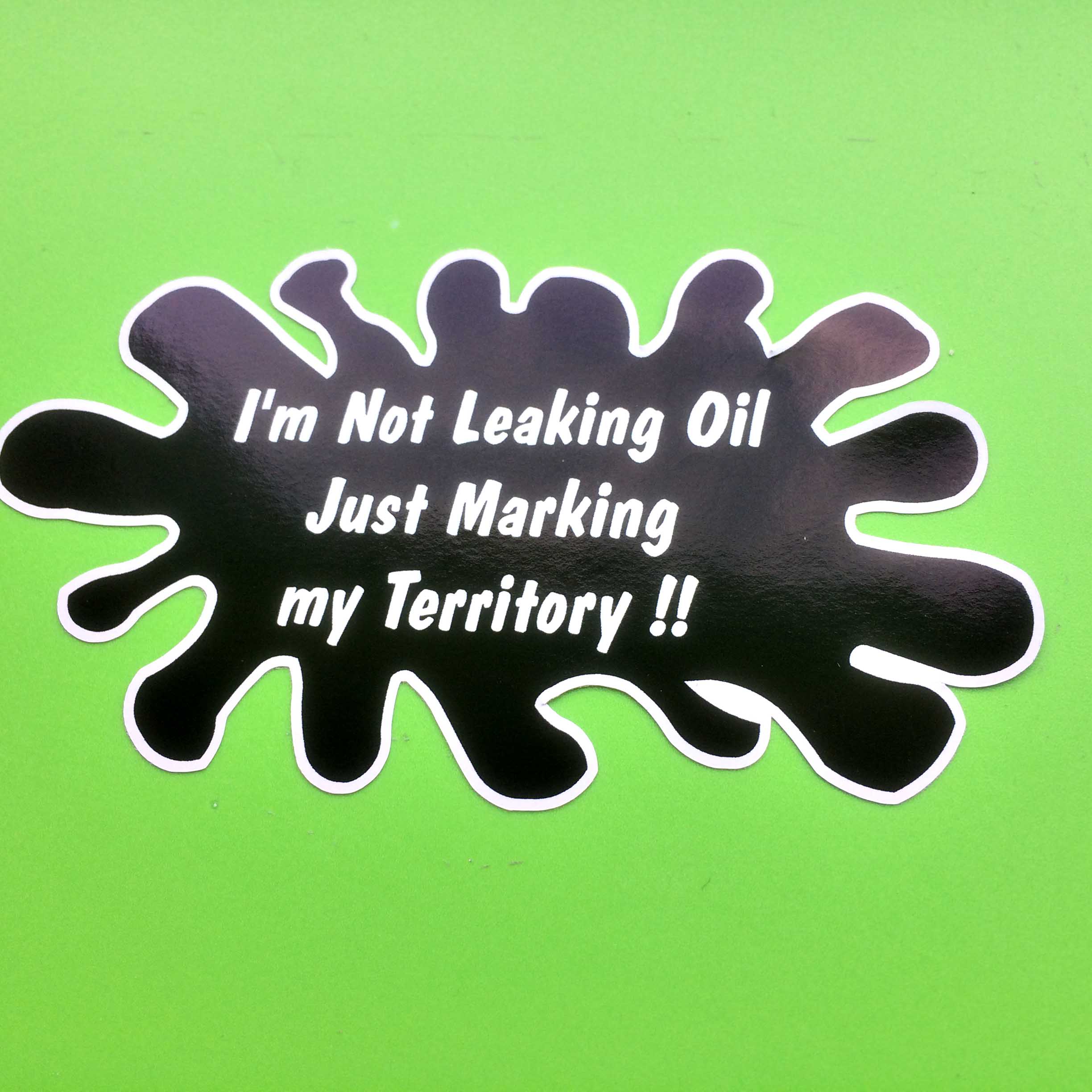 I'M NOT LEAKING OIL STICKER. I'm Not Leaking Oil Just Marking my Territory!! in white lettering on a black oil splat.