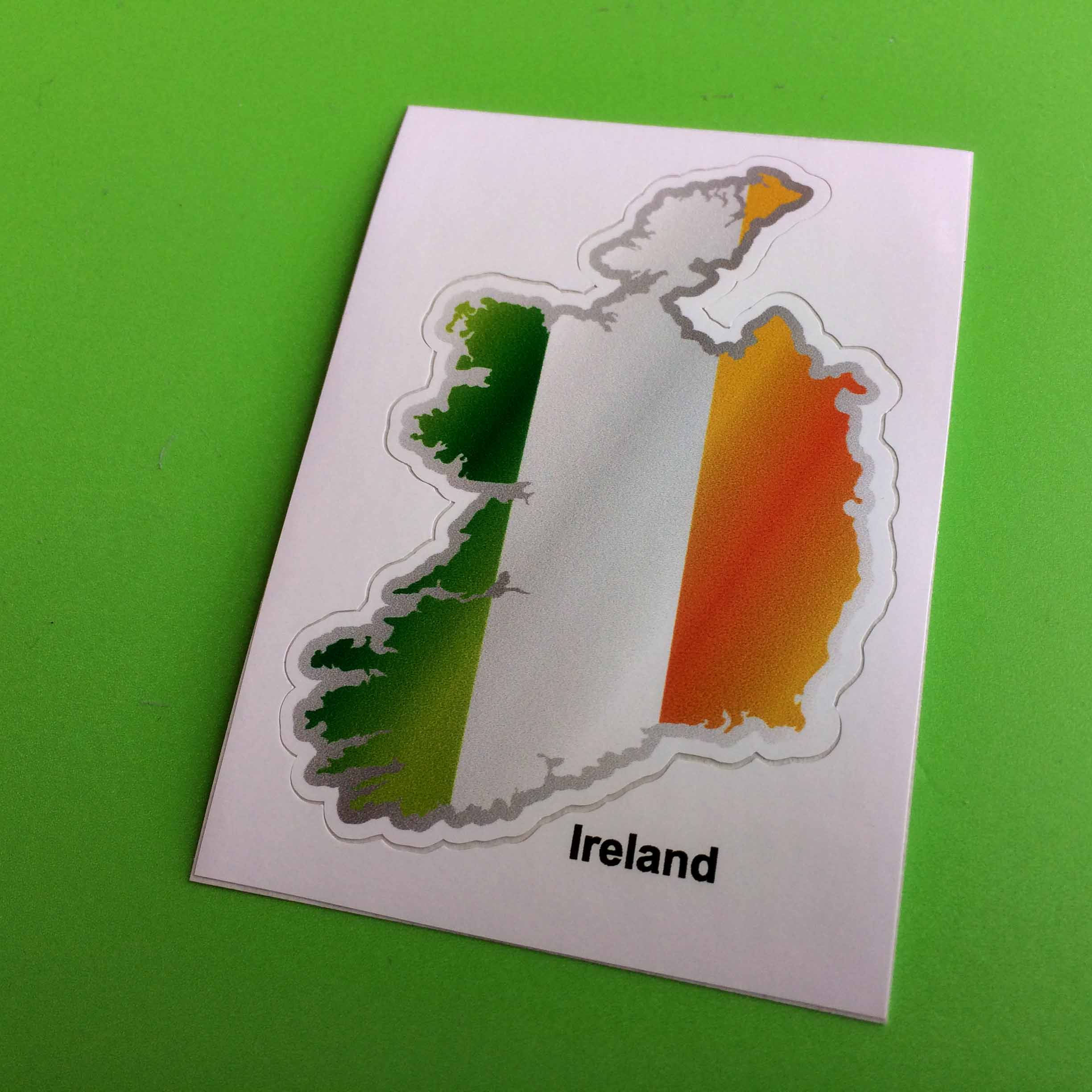 An Ireland flag and map. A vertical tricolour of green, white and orange.