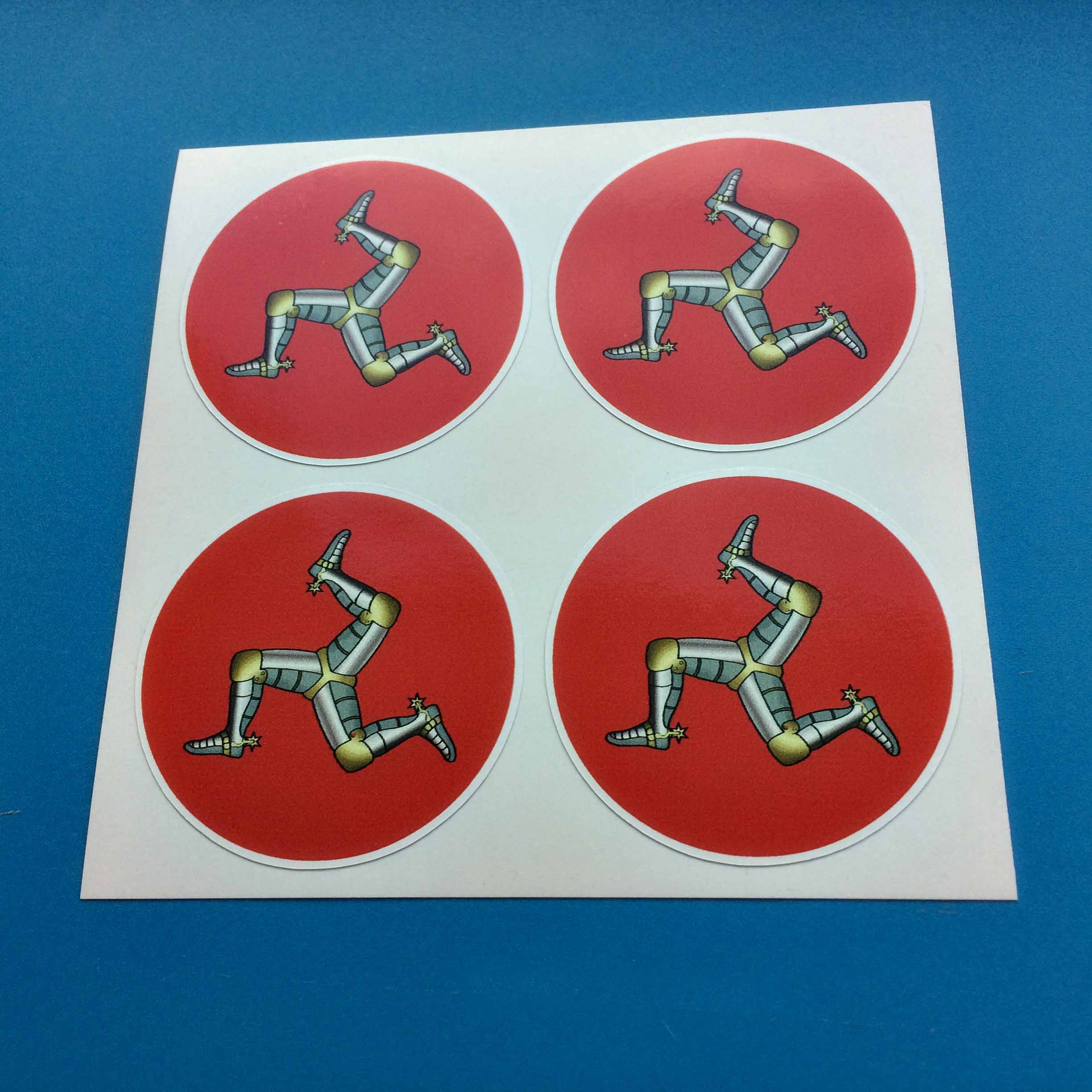 ISLE OF MAN WHEEL CENTRE STICKERS. Three armoured legs with golden spurs on a red circular background.