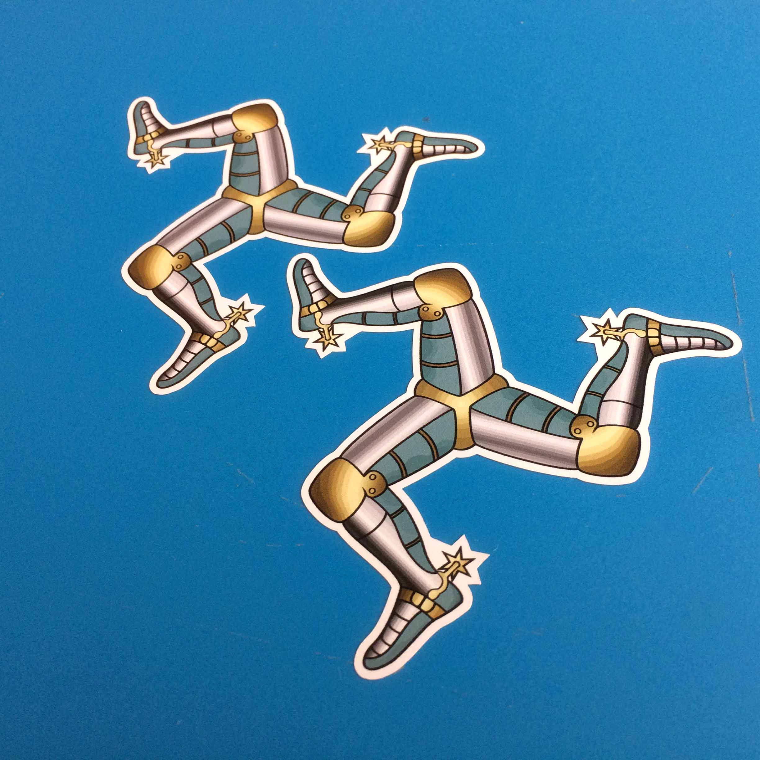 ISLE OF MAN LEGS TRISKELION STICKERS. Three armoured legs with golden spurs.