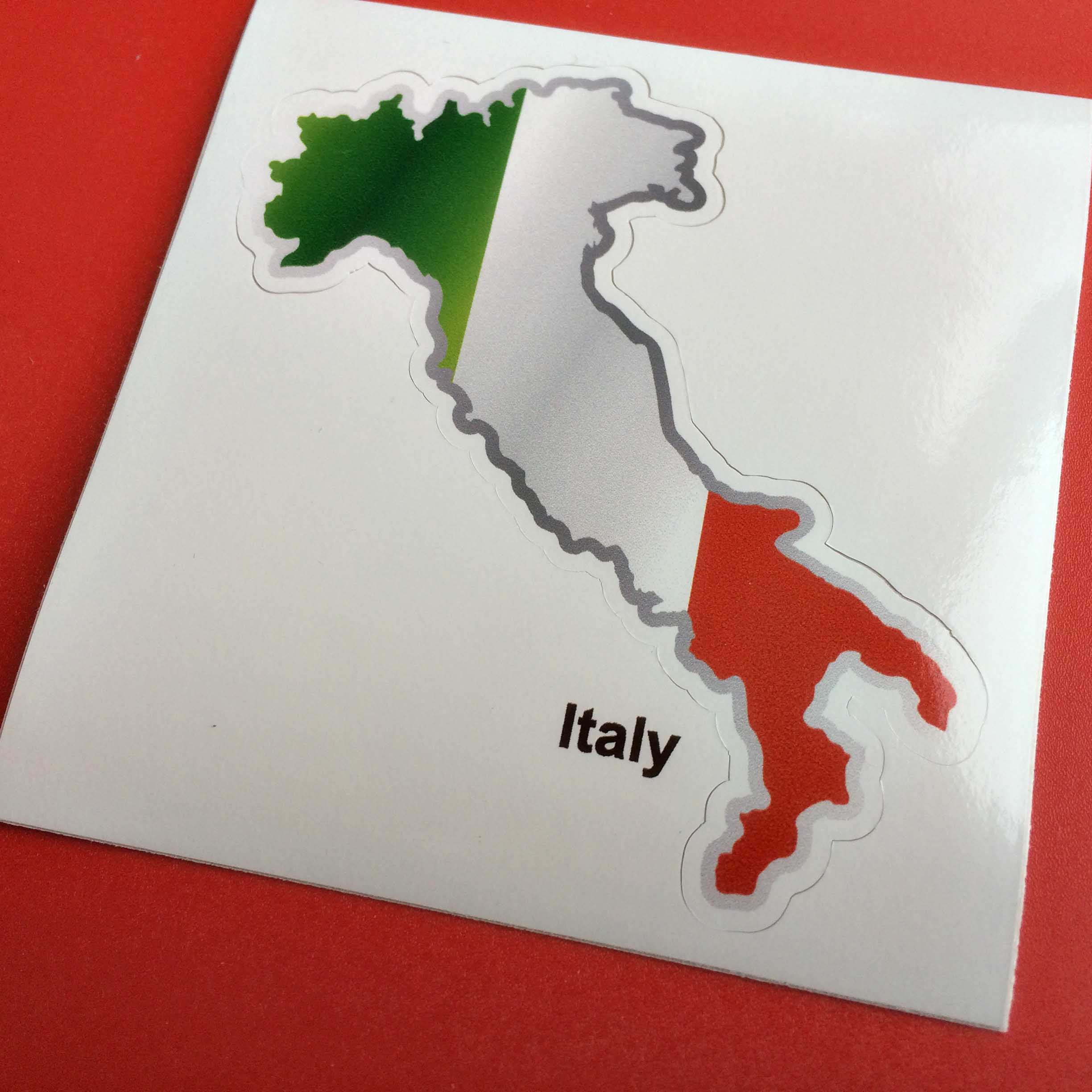 The green, white and red flag and map of Italy.