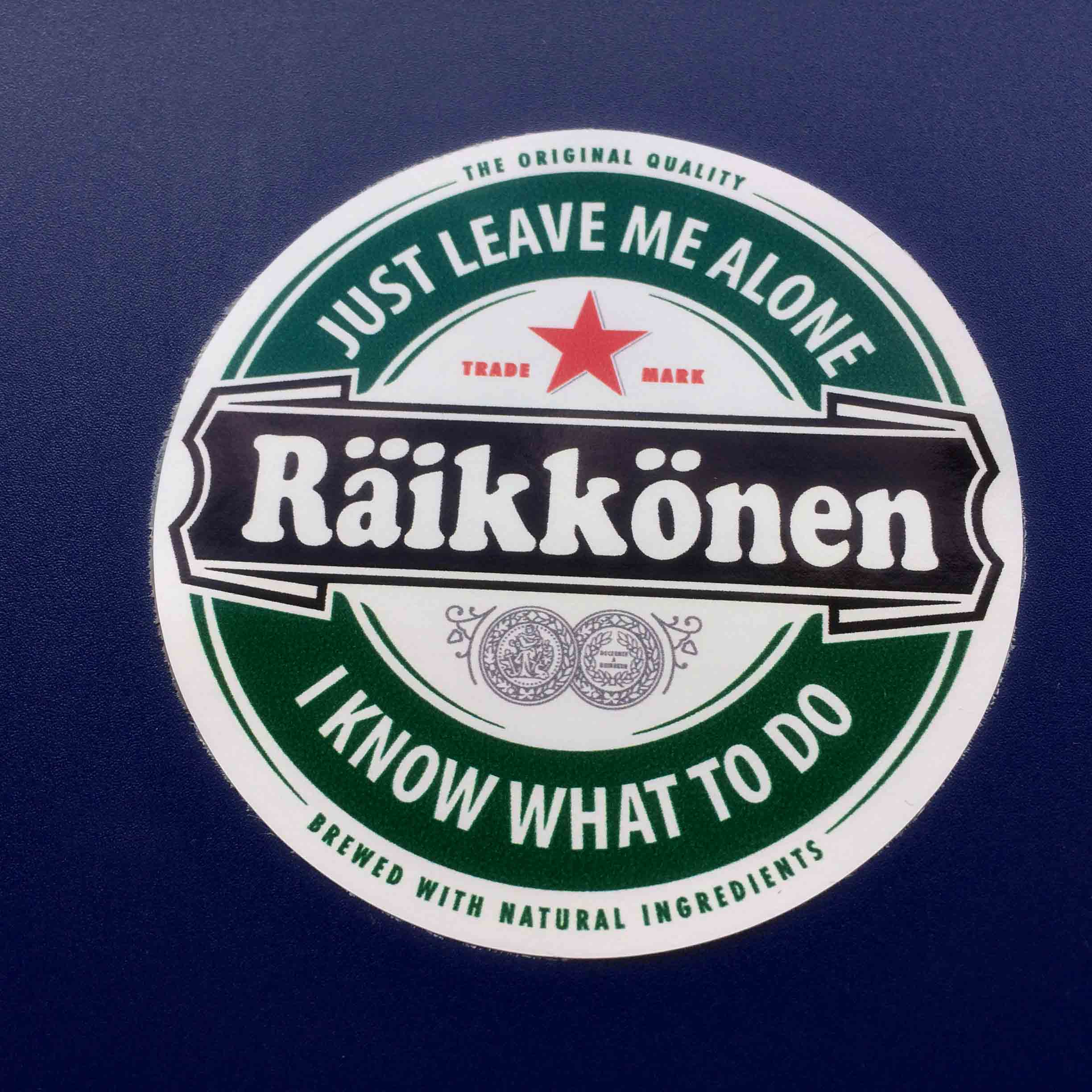 Imitating the Heineken logo. A green circular sticker with a red star. Raikkonen Just Leave Me Alone I Know What To Do. The Original Quality Brewed With Natural Ingredients.