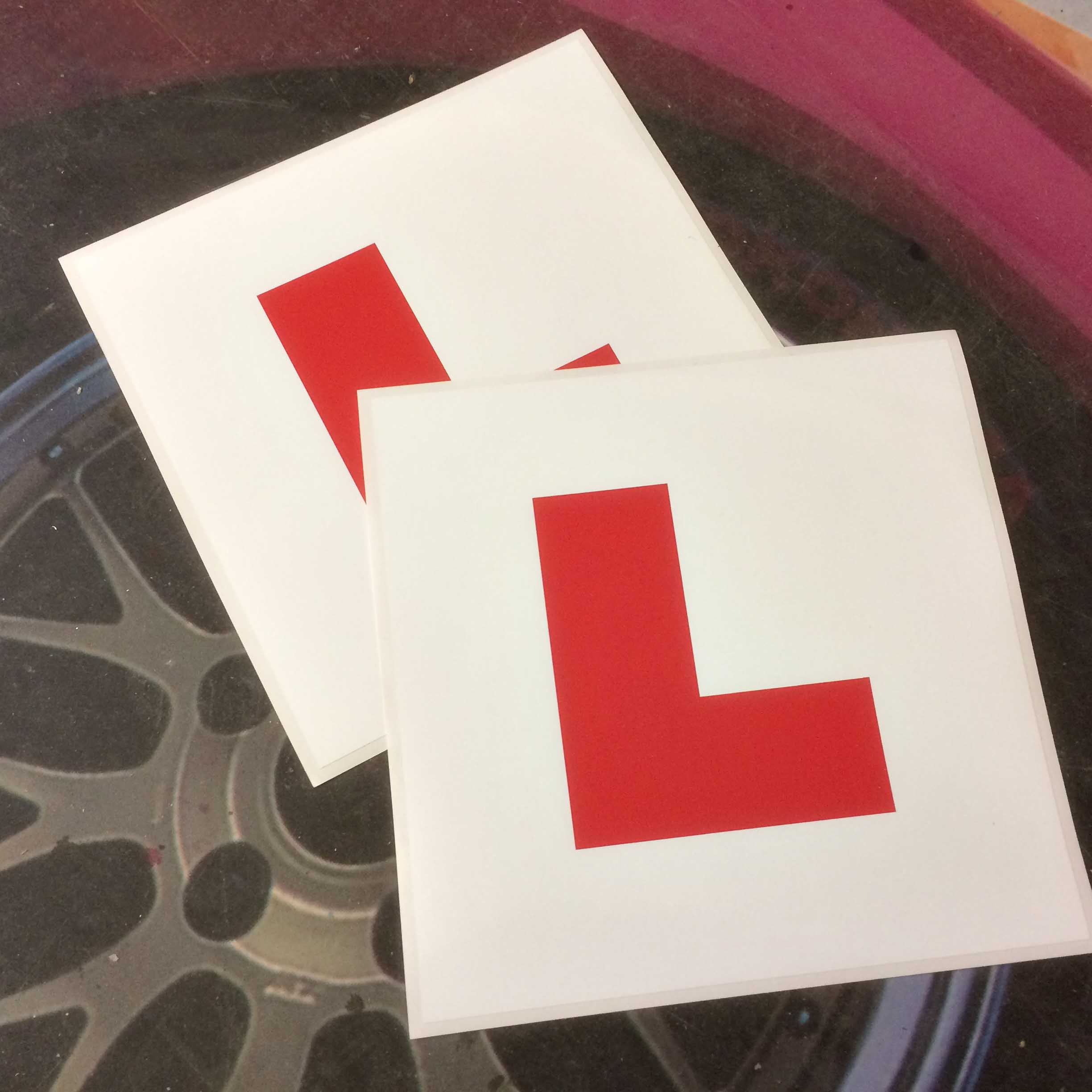 L PLATE LEARNER DRIVER STICKERS. Capital L in red on a white bakground.