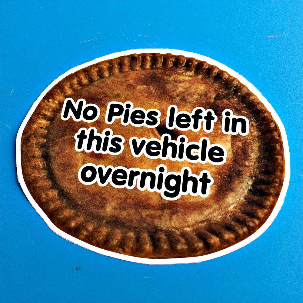 No Pies left in this vehicle overnight. Black lettering covering a round pie with a crust.