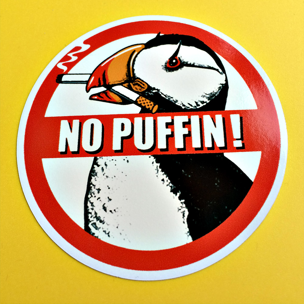 Prohibition symbol No Puffin! In the background is a puffin with a cigarette between it's beak.