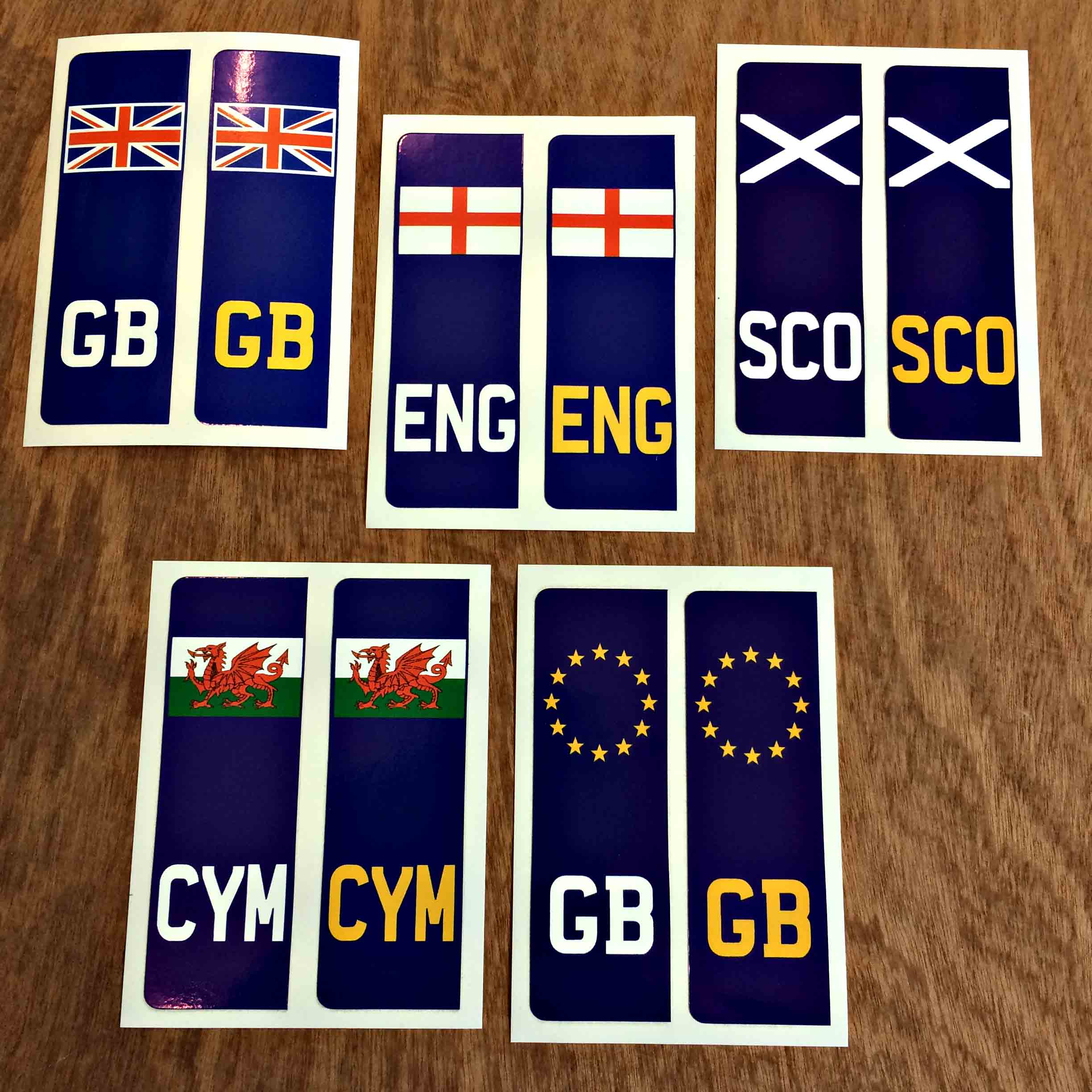NUMBER PLATE ORIGIN STICKERS. A blue column. Top is the country flag. Bottom is GB, ENG, SCO or CYM. The lettering is white and yellow.