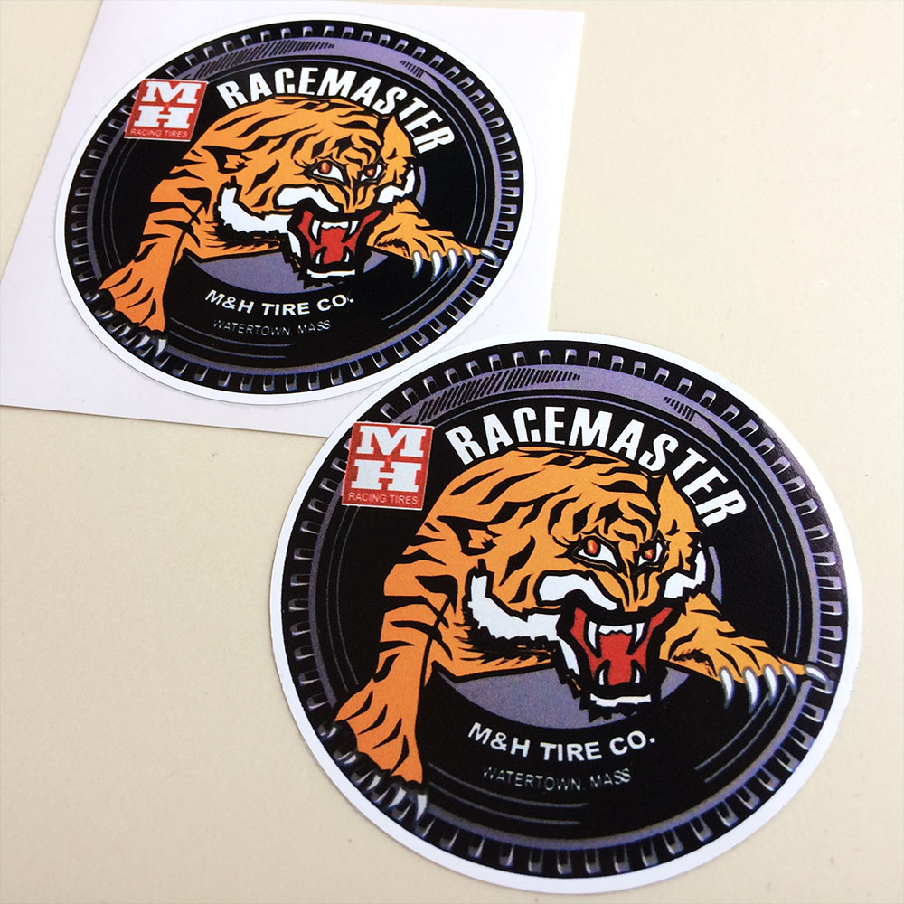 RACEMASTER TIRE COMPANY STICKERS. Black tyre with a tiger in the centre. Racemaster M&H Tire Co. Watertown Mass. in white. Additional lettering MH Racing Tyres.