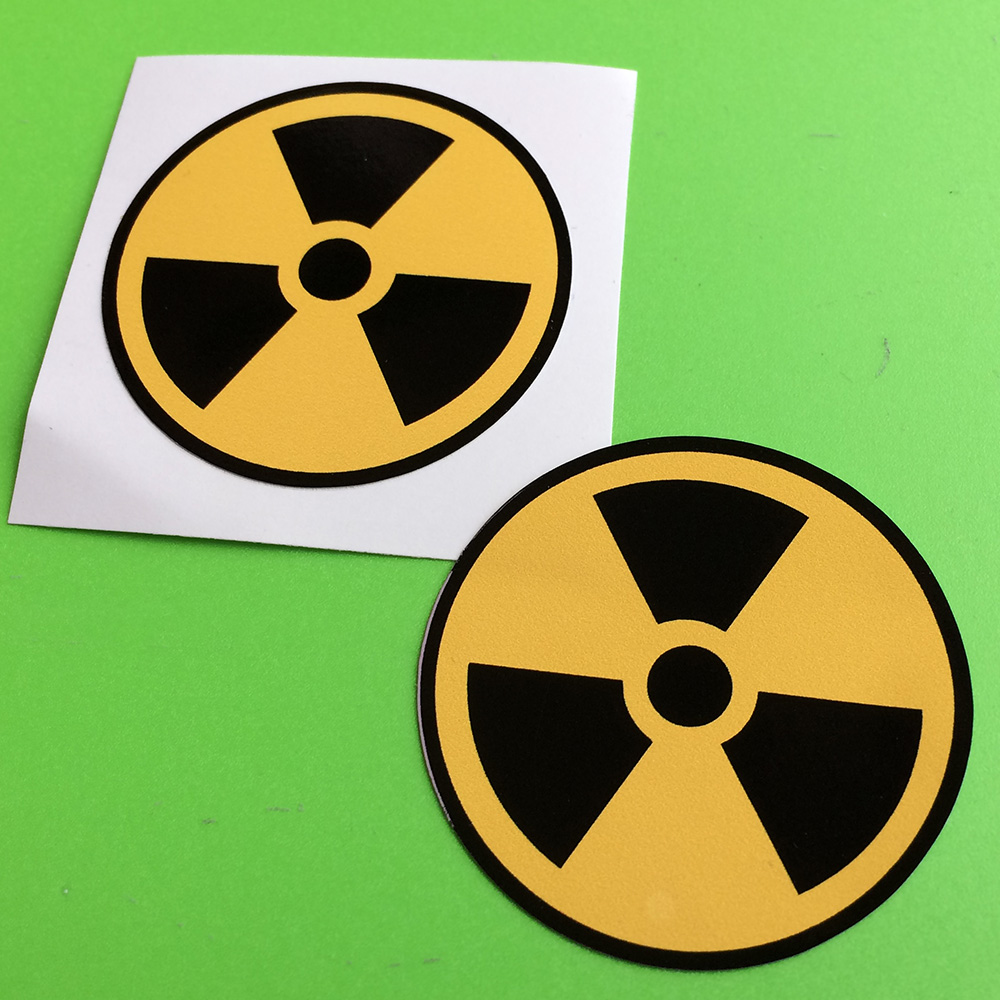 RADIOACTIVE RADIATION NUCLEAR SAFETY STICKERS. A black propeller on a yellow circular background.
