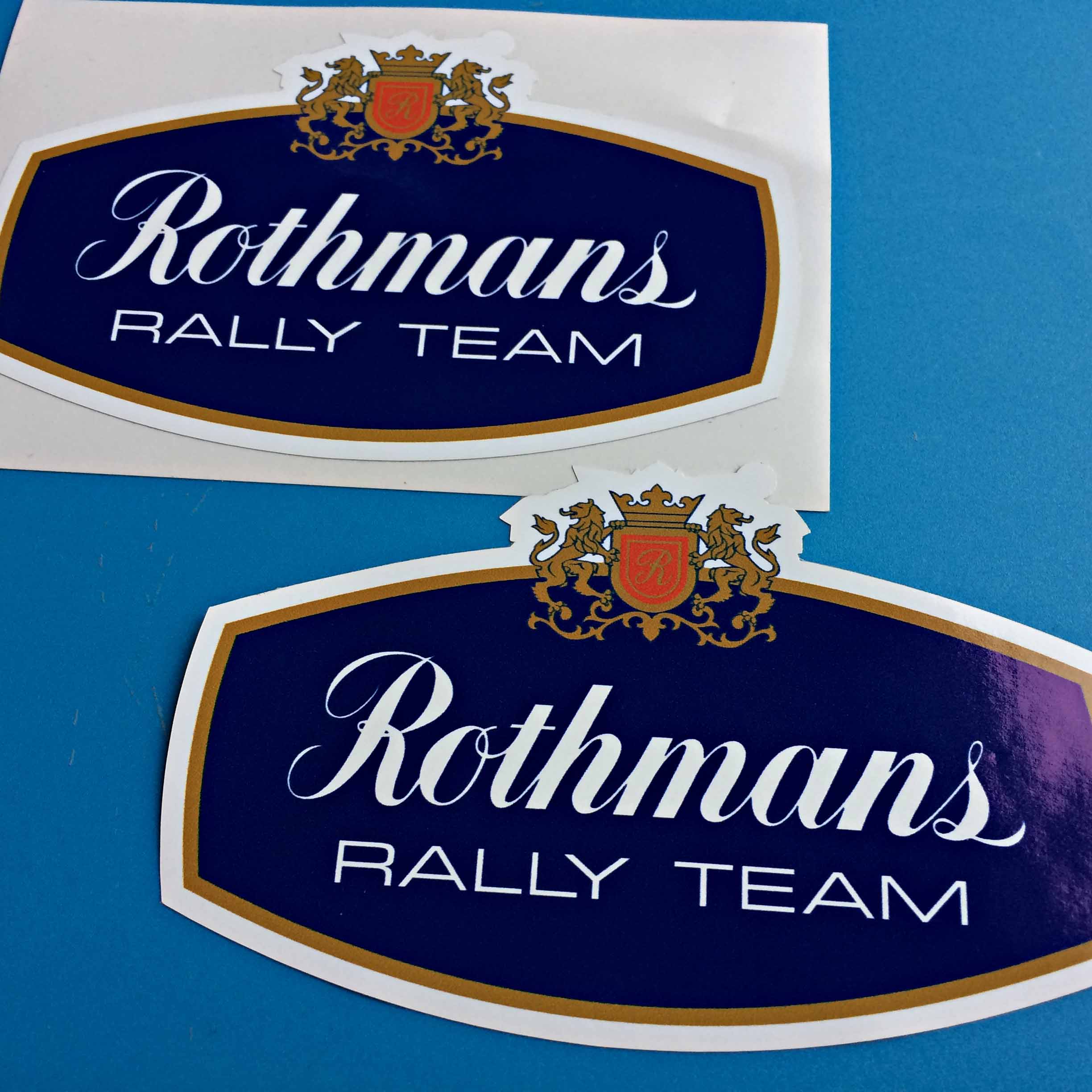 ROTHMANS RALLY TEAM STICKERS. Rothmans Rally Team in white lettering on a blue background. Two golden lions are either side of a gold crown and shield. The shield has a gold R on a red background.