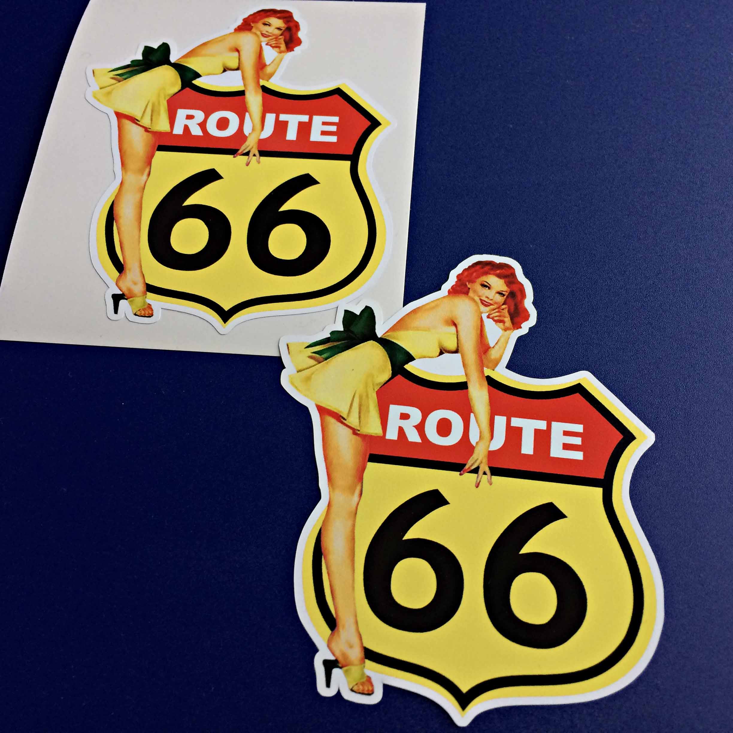 ROUTE 66 AND STANDING MODEL STICKERS. Route 66 sign in yellow. Route white lettering on red and 66 in bold black. A model wearing a short yellow dress with a black bow and yellow heels leans over the sign.