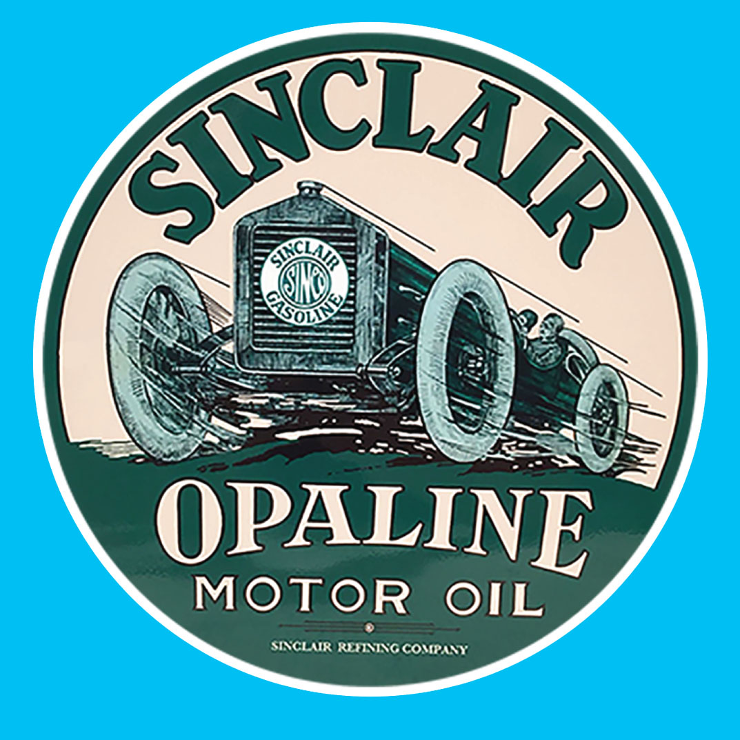 A circular sticker in green and white. Sinclair Opaline Motor Oil lettering surrounds a vintage motorcar with a Sinclair Gasoline logo on the grill driven by a man wearing goggles and a helmet.