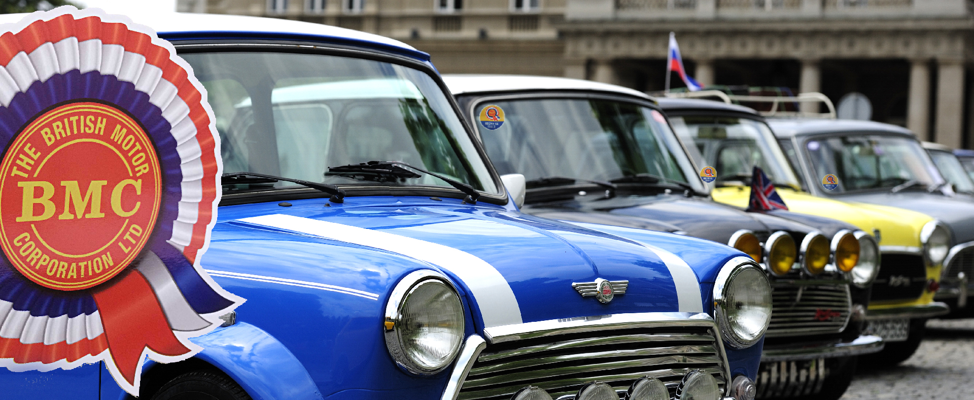 BMC-STICKER-MONTAGE. A row of classic mini cars lined up displaying the BMC stickers available on this website