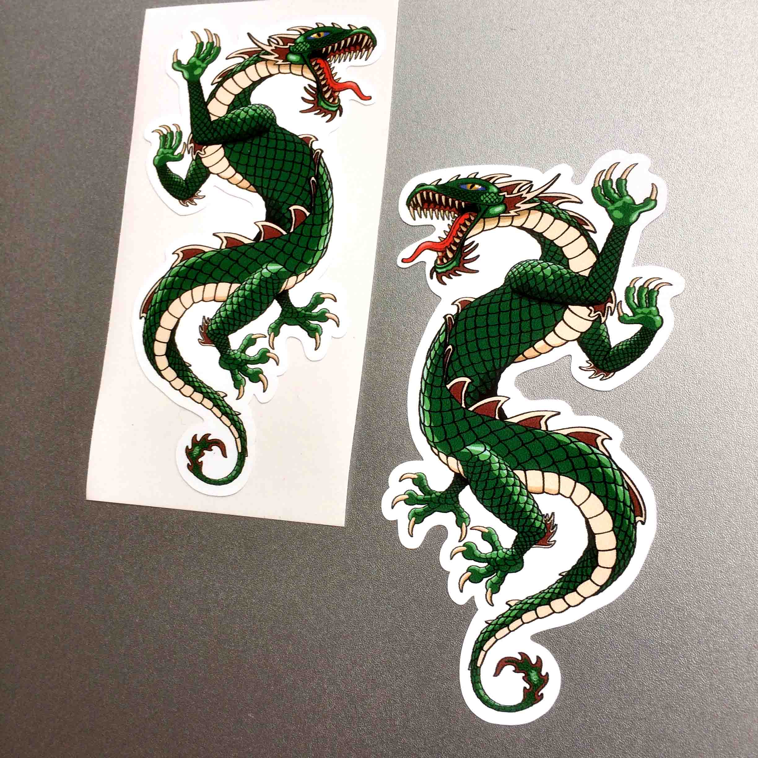 DRAGON STICKERS. A four legged green dragon with scaly skin, a tail and jaws wide open displaying a red tongue and sharp teeth.