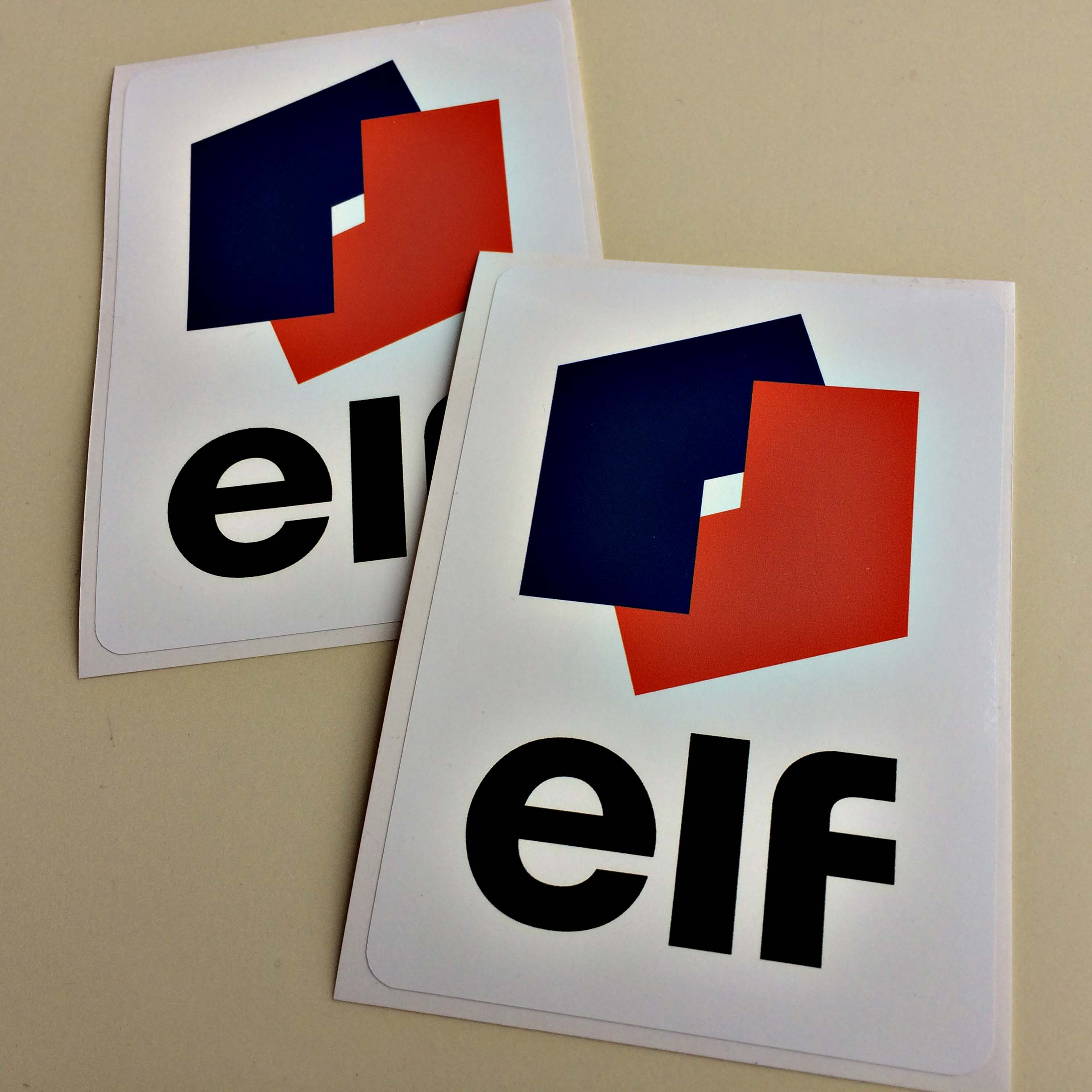 ELF RALLY STICKERS logo; two interlocking L shapes in blue and red on a white sticker with Elf in bold black lowercase lettering below.
