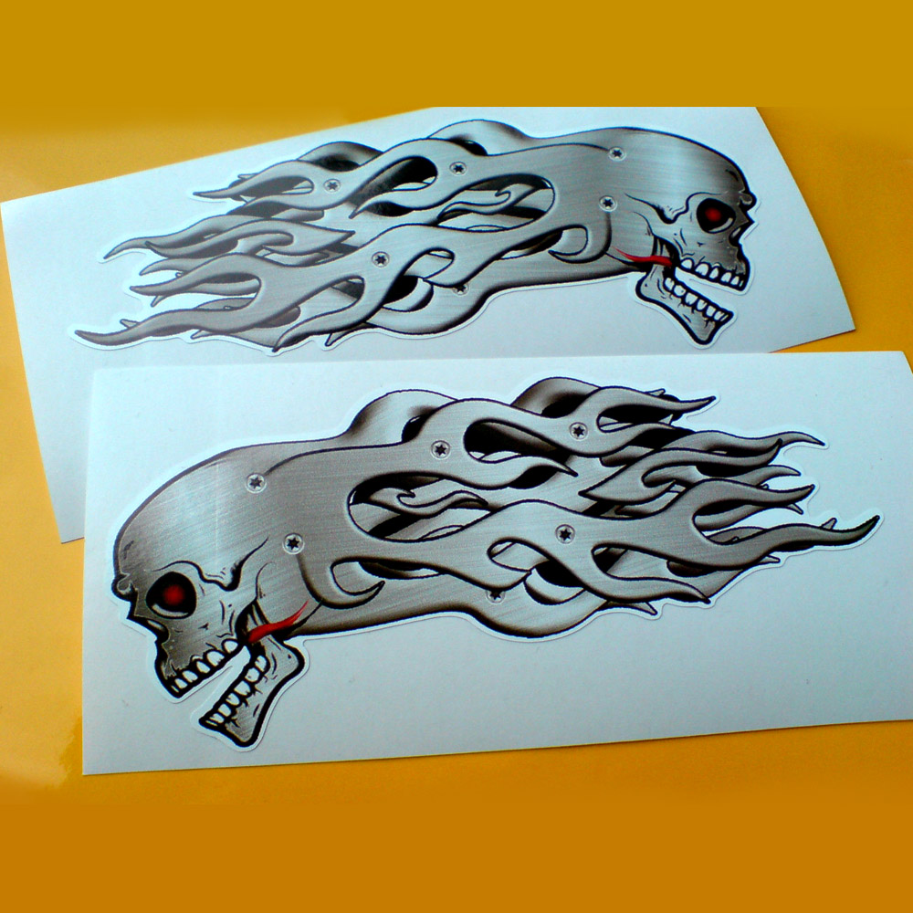 SKULL AND METAL FLAMES STICKERS. Skull is side on facing down. Eye socket is red and black. Teeth white with a red flame coming from the mouth. Flames behind. Metal effect skull and flames.