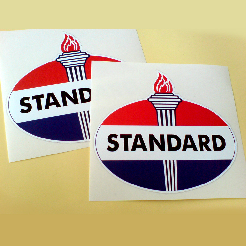 An oval sticker. Three bands of red, white and blue. Standard in black lettering on the white band. A large torch with a red flame is in the centre.