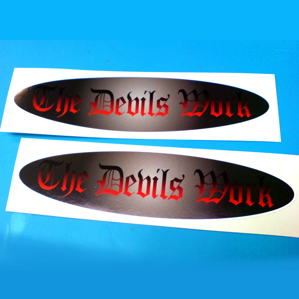 THE DEVILS WORK HOT ROD STICKERS. The Devils Work in red Gothic lettering on a dark metallic looking oval background.