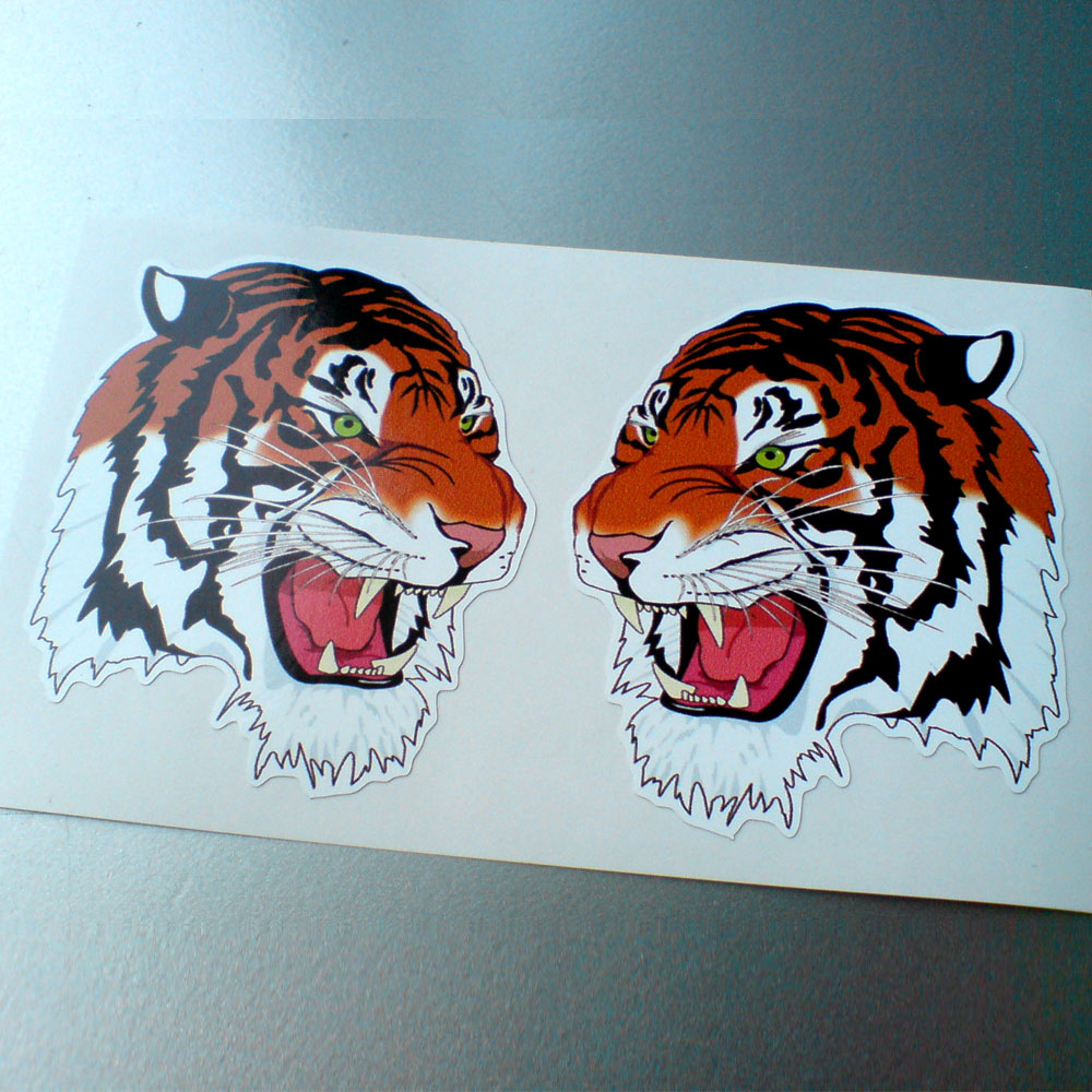 TIGER HEAD STICKERS (1 PAIR HANDED). A tigers head. Black vertical stripes on orange and white fur. The eyes are green. The jaws are open displaying sharp white teeth and a pink tongue.