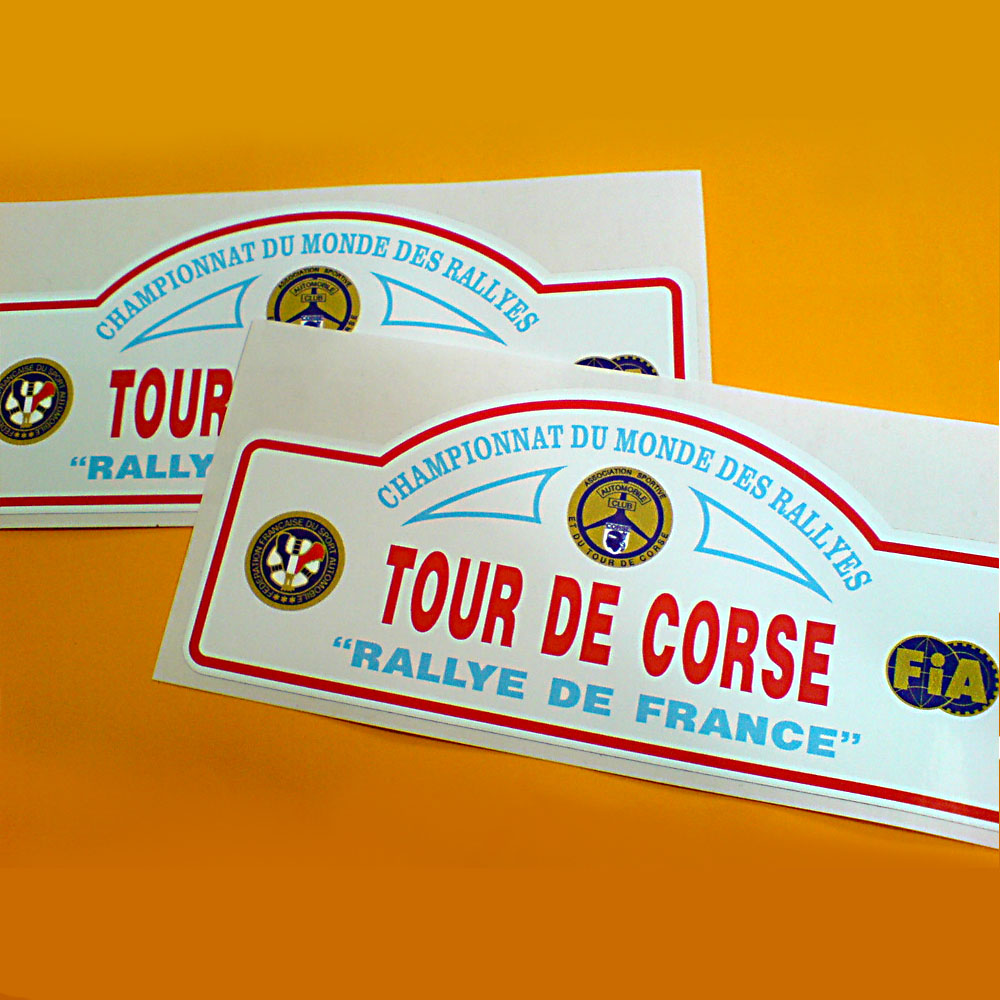 TOUR DE CORSE RALLY CAR STICKERS. Tour De Corse in bold red lettering. Above in blue lettering Championnat Du Monde Des Rallyes and below "Rallye De France" on a white background and a red border. Also the logos of the FIA and two other motorsport governing bodies.