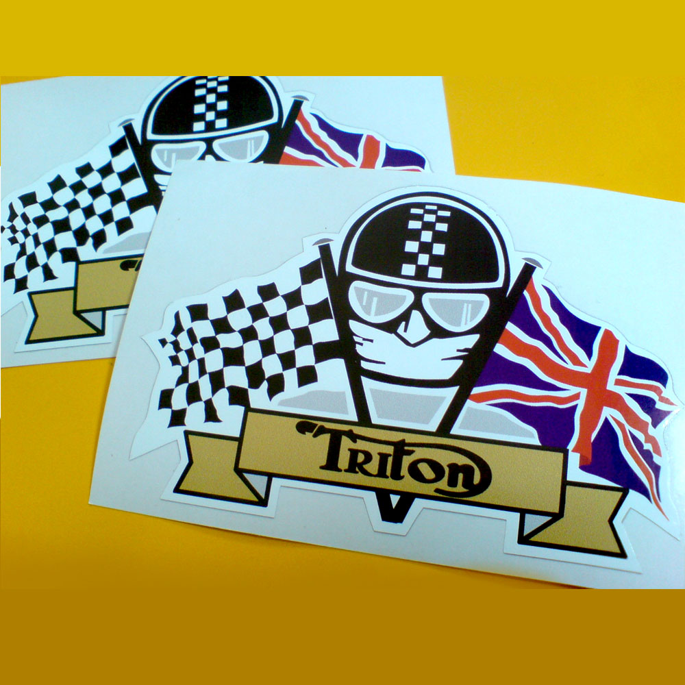 Triton logo in black on a gold banner. Above is the face of a motorcyclist wearing goggles, a white scarf and a black helmet with a chequer strip. He sits between crossed flags. A Union Jack and a chequered flag.
