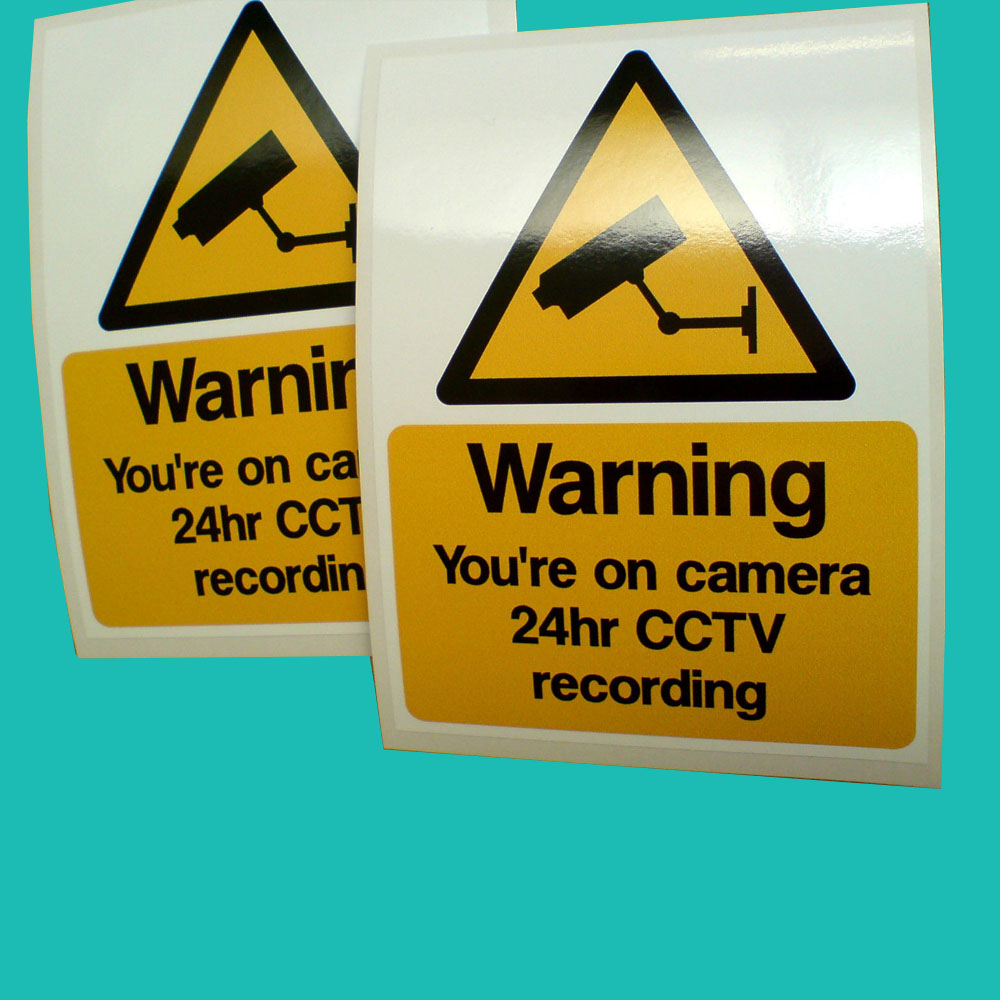 WARNING YOU'RE ON CAMERA CCTV STICKERS. Warning You're on camera 24hr CCTV recording in black lettering on a yellow rectangle. Above is a black and yellow camera warning triangle.