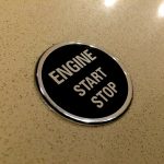 ENGINE START STOP DOMED RESIN GEL STICKER. Engine Start Stop in uppercase chrome lettering on a black background. Chrome edged round, domed sticker.