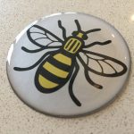 MANCHESTER BEE DOMED RESIN GEL STICKER. Black and yellow bee on a round, domed sticker.