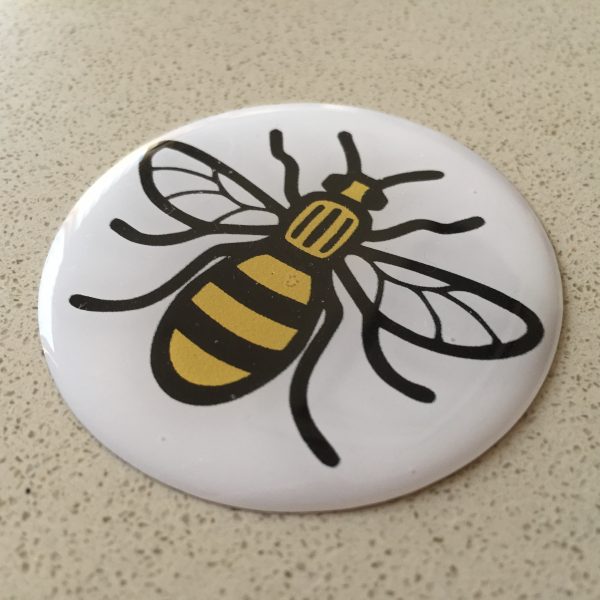 Black and yellow bee on a round, domed sticker.