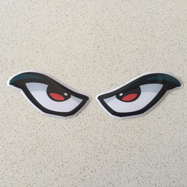 EVIL EYES DOMED RESIN GEL STICKER. A pair of evil eyes. Whites of the eyes outlined in black. Red and black pupils.