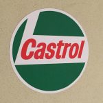 Castrol Oil, circular sticker in red, white and green. Castrol bold, red, lowercase lettering on a white L shaped background. White edging. Green background.