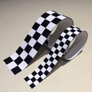 CHEQUERED TAPE BLACK AND WHITE. A strip of black and white chequered tape.