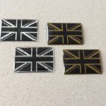 A domed chrome effect Union Jack in black and silver or black and gold.