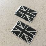 A Union Jack in black and silver or black and gold. A chrome effect and domed.