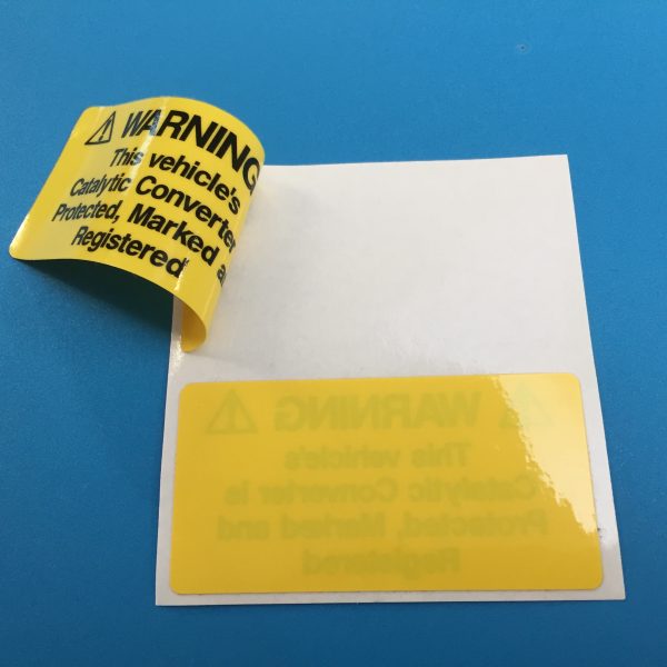 WARNING! CATALYTIC CONVERTER STICKERS. Catalytic Convertor Warning Stickers. Black text on either a yellow, white or silver background. With the word Warning in bold capital letters. The rest of the text 'This vehicle's Catalytic Converter is Protected, Marked and Registered' in lower case.