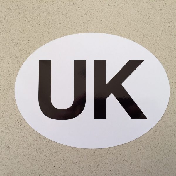 UK STICKER FOR CARS. White oval shaped sticker, with letters UK printed in black.